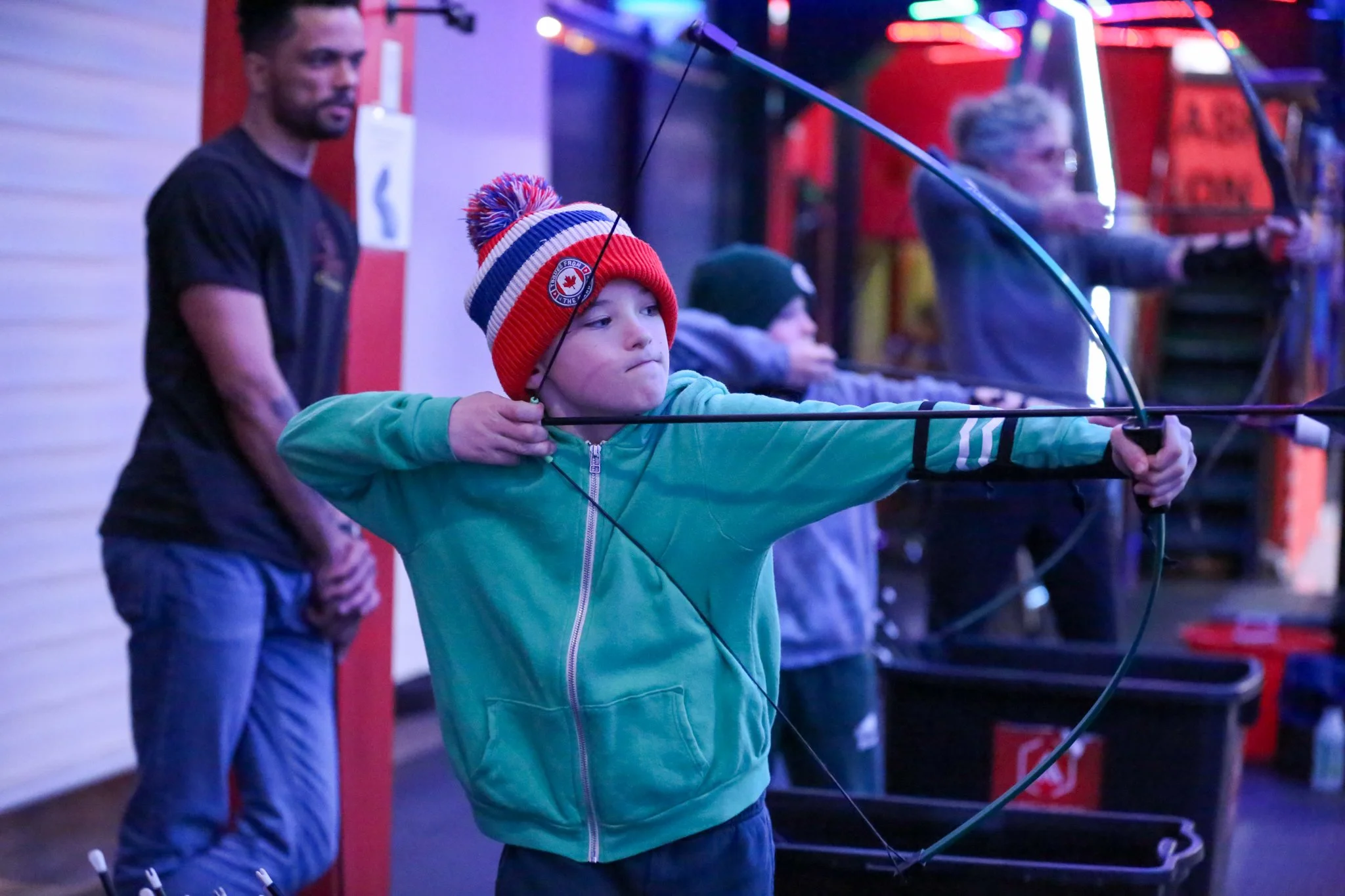 Family participating in a fun archery session together in Toronto