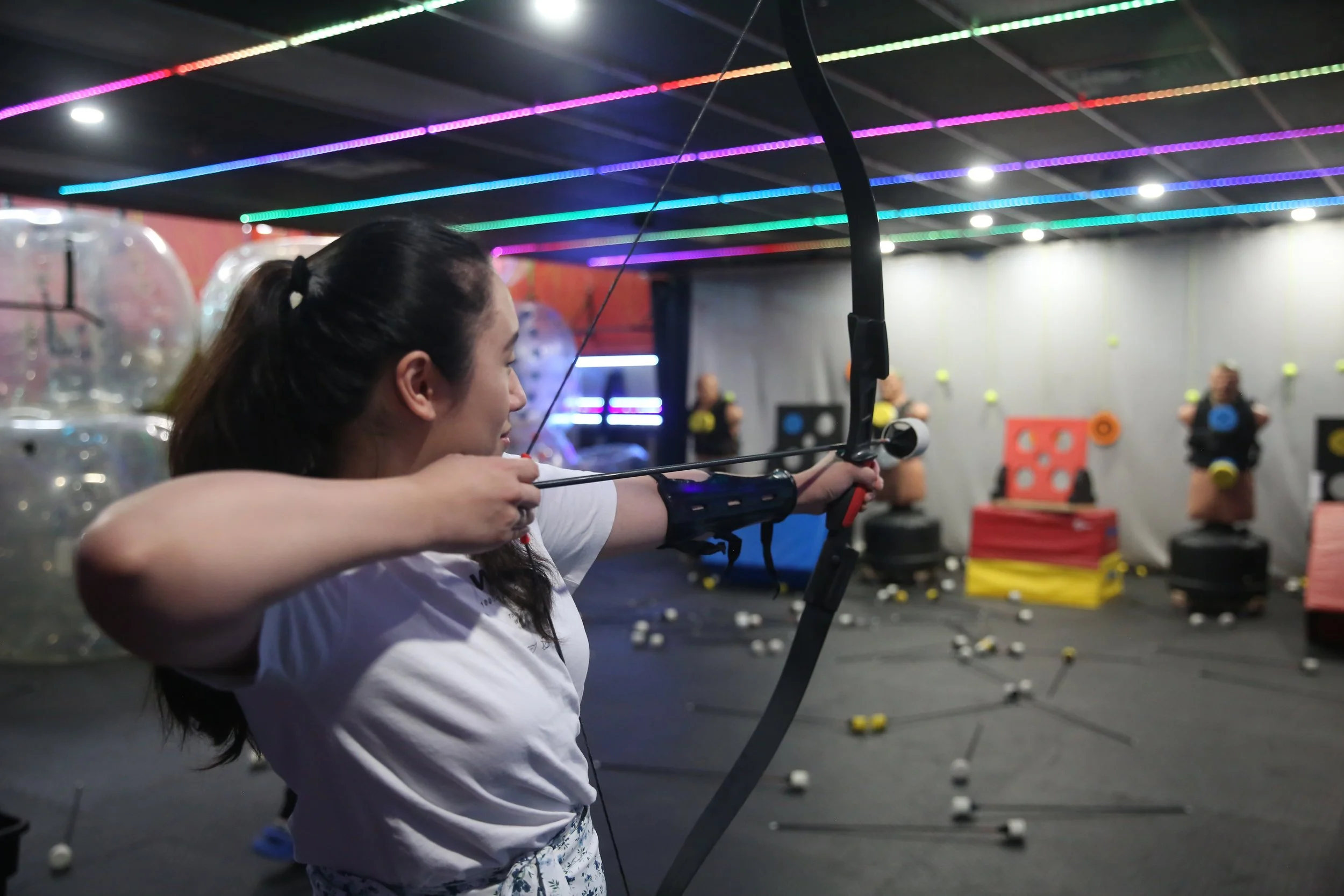 Beginner learning archery during an indoor activity in Toronto