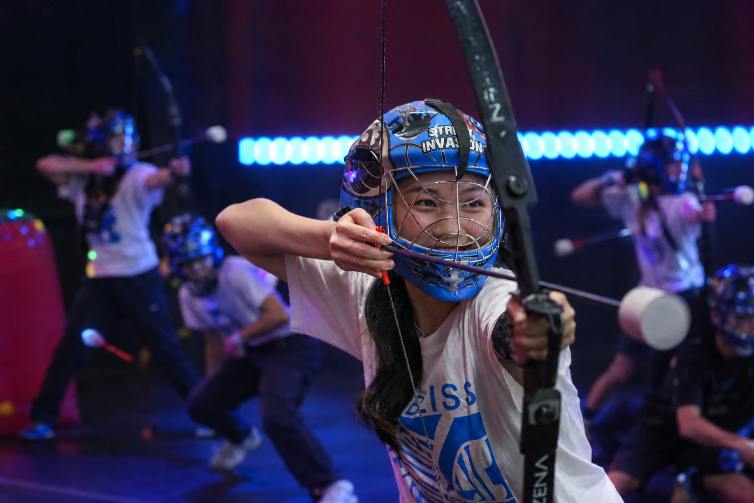 Friends playing indoor combat archery together in Toronto