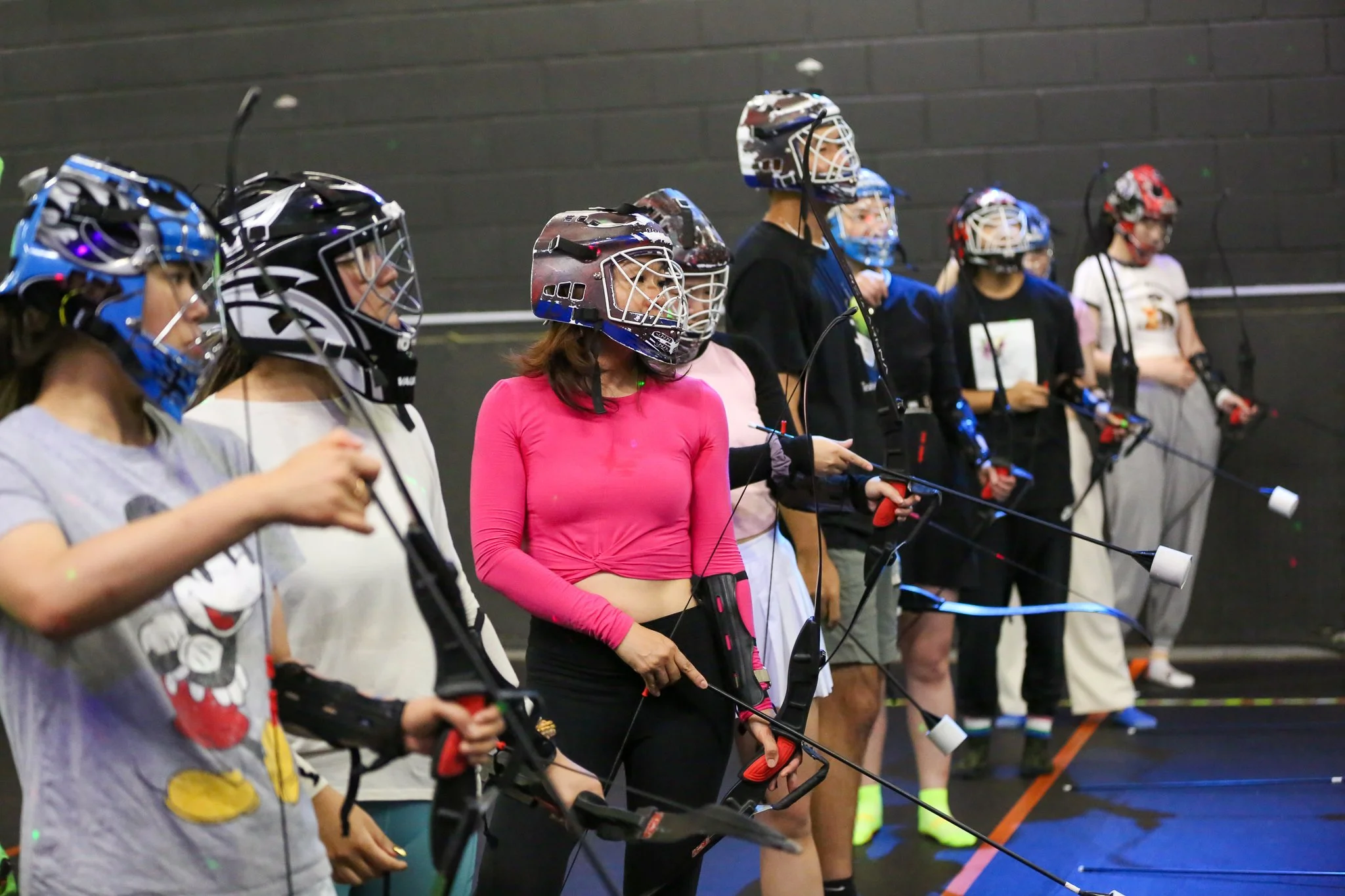Employees competing in a Combat Archery corporate event in Toronto