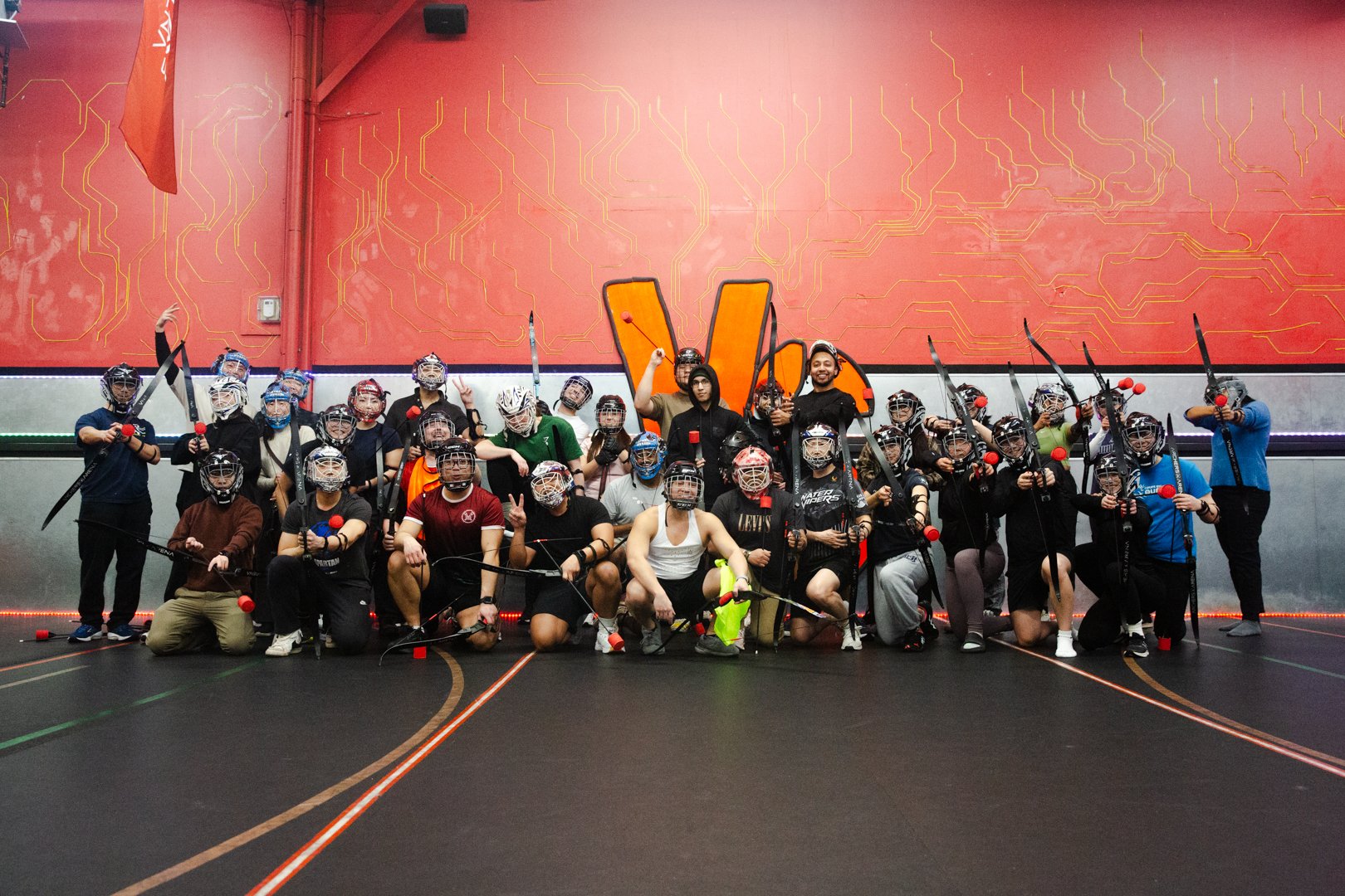 mixed group of players and coaches playing combat archery thursday event