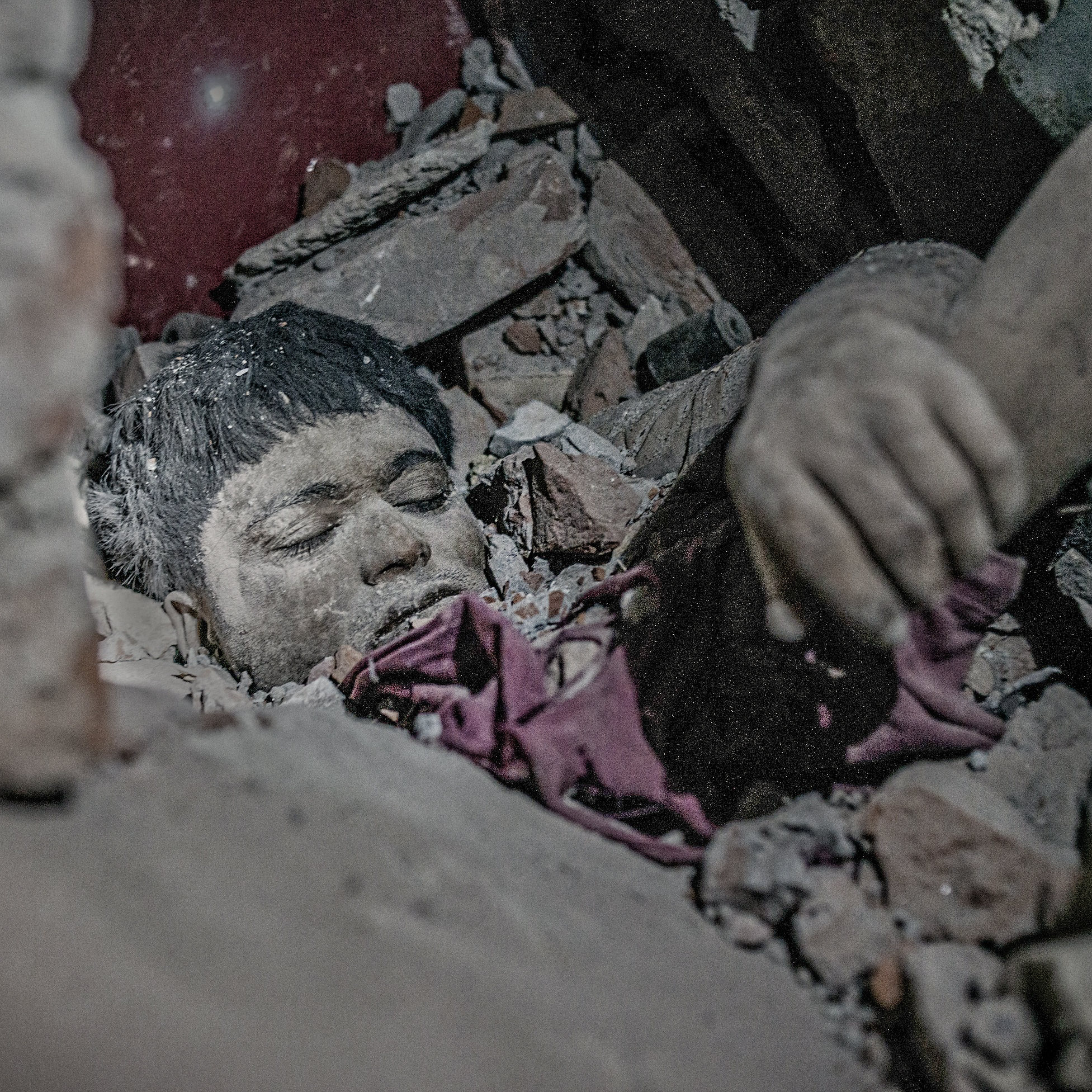 A dead body stuck in rubble of rana plaza