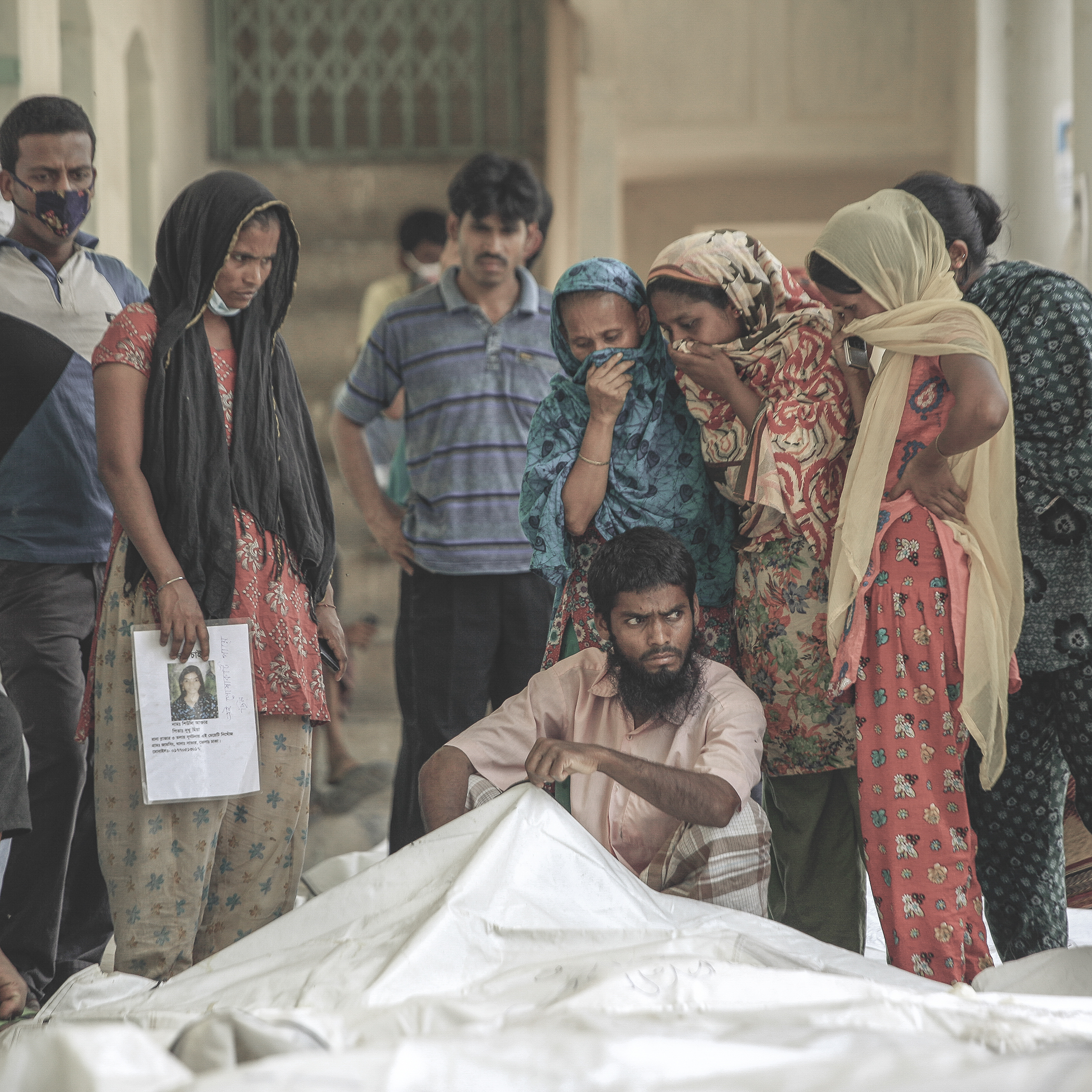 Dead body of a Rana Plaza incident victim in front of relatives  of lost people