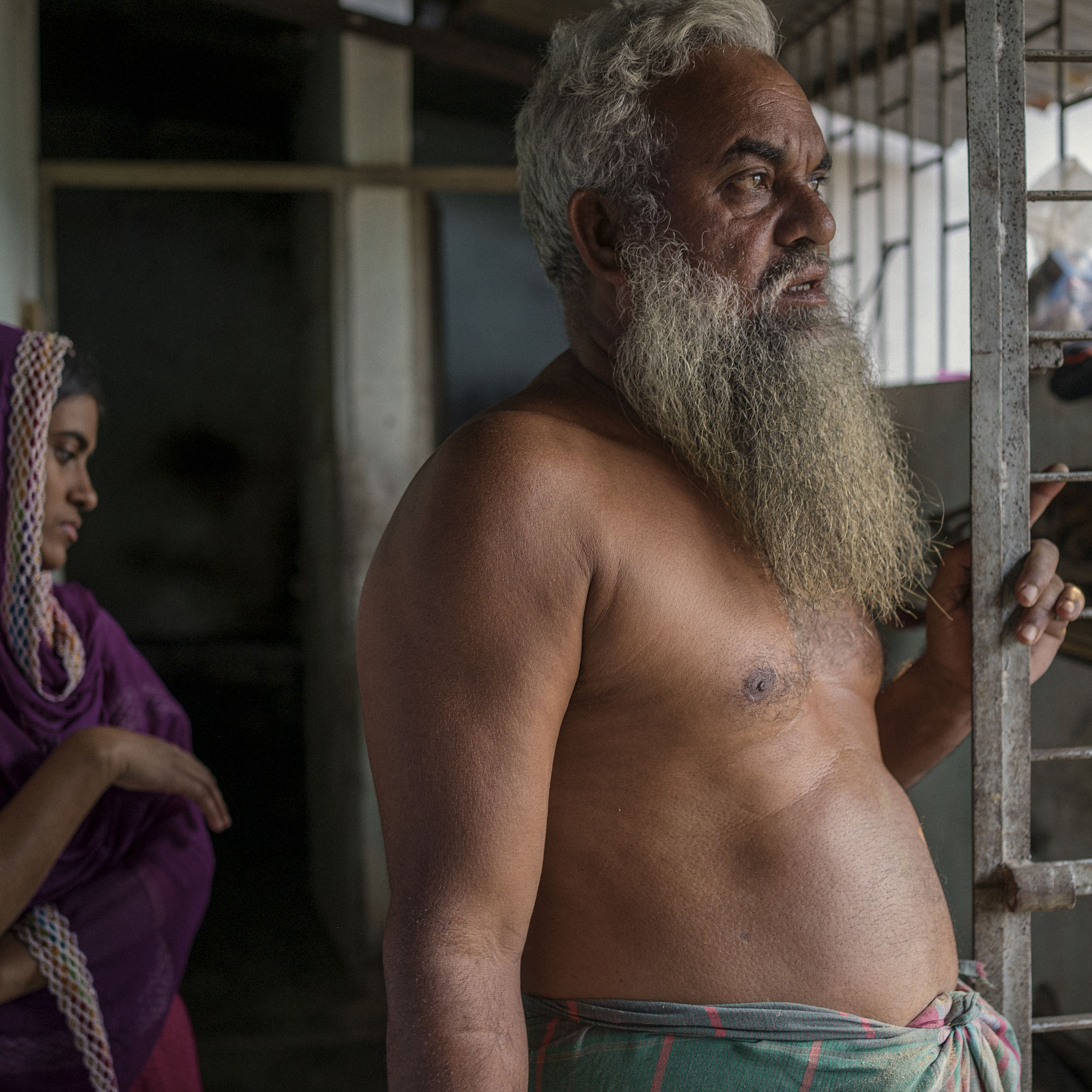 Toslim Mulla, a distant relative of Taslima, looks blankly at the window through which Rana Plaza could be viewed from their house, and gives an account of the disaster.