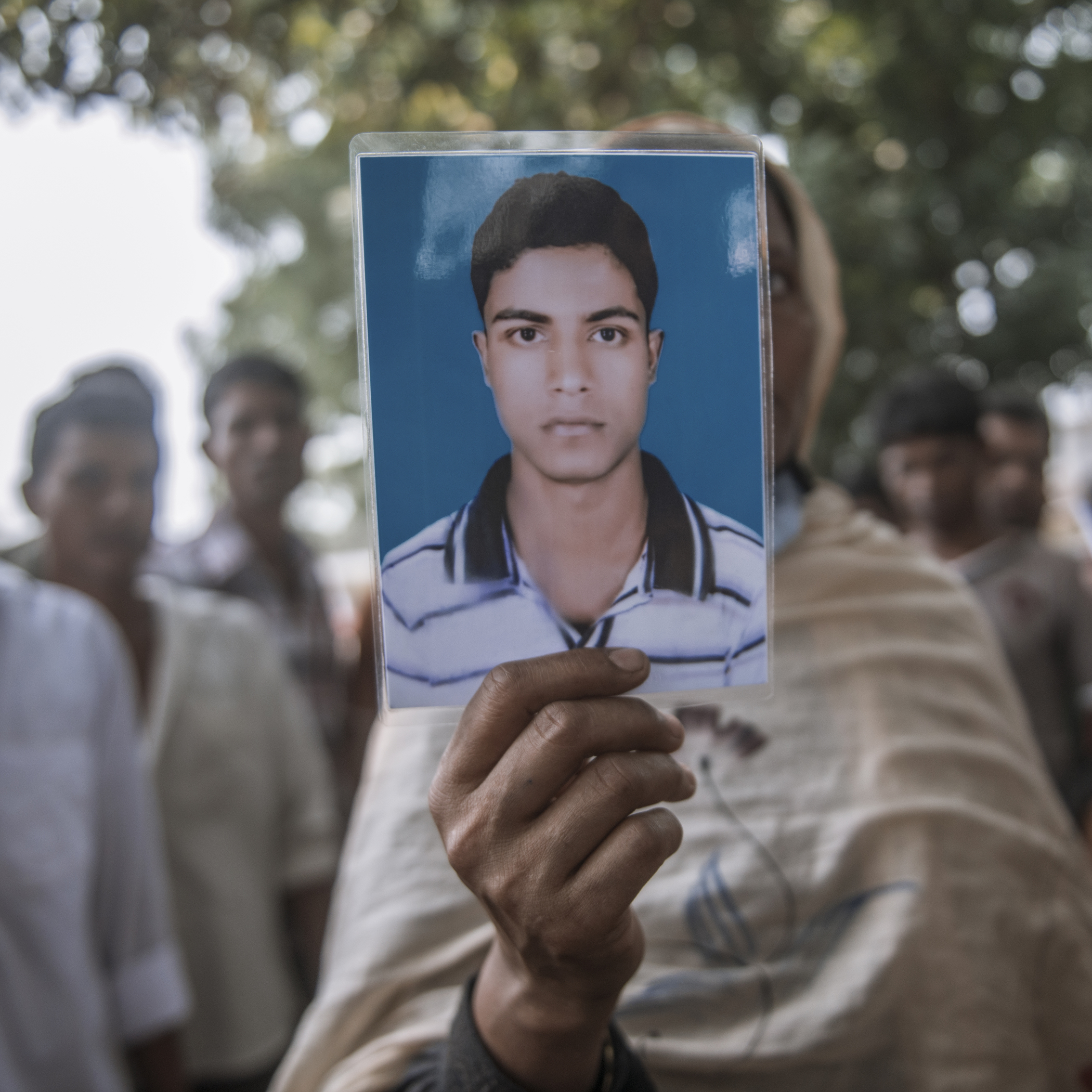 Firoza Begum holds up her grandson Shohag’s photo at the Adhar Chandra School field, where the bodies of Rana Plaza victims were kept after the building collapsed.