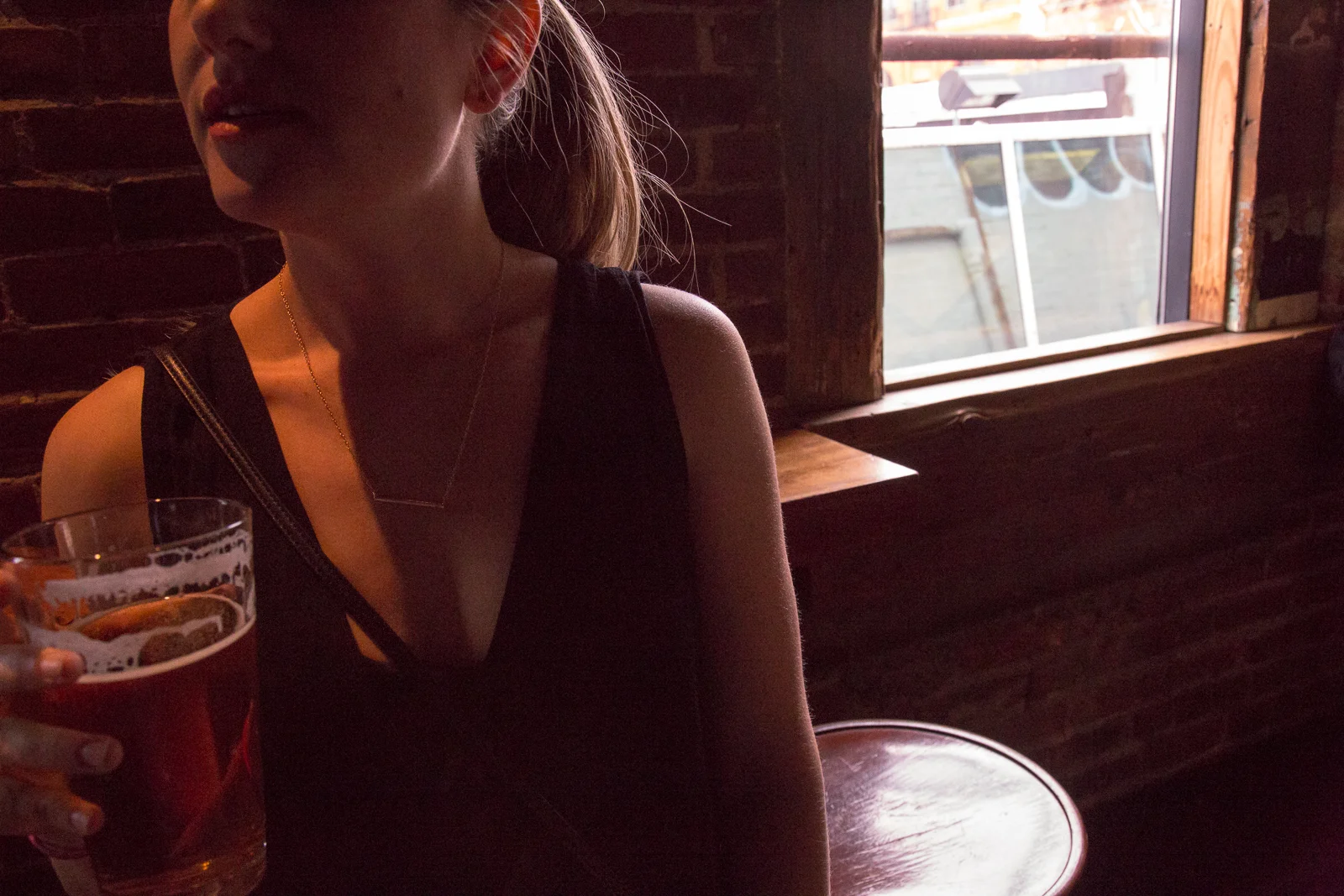 girl with beer by window.jpg