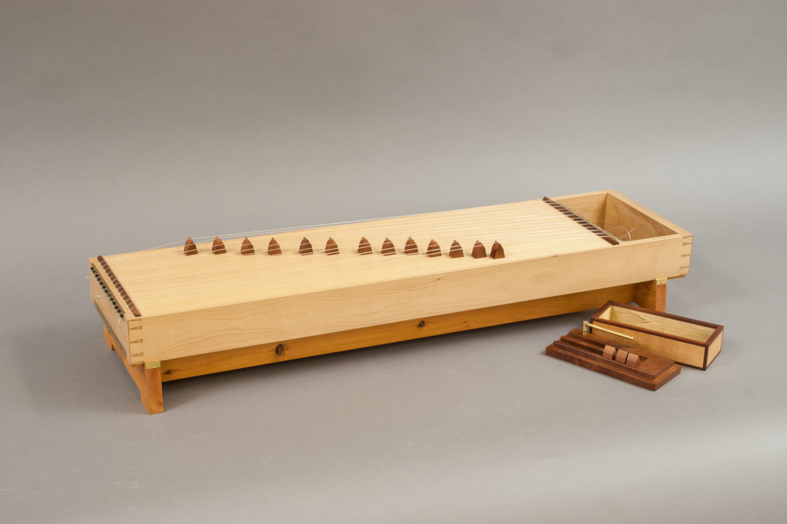 The Cabinetmaker's Zither is an original design for a stringed instrument, made from local woods.