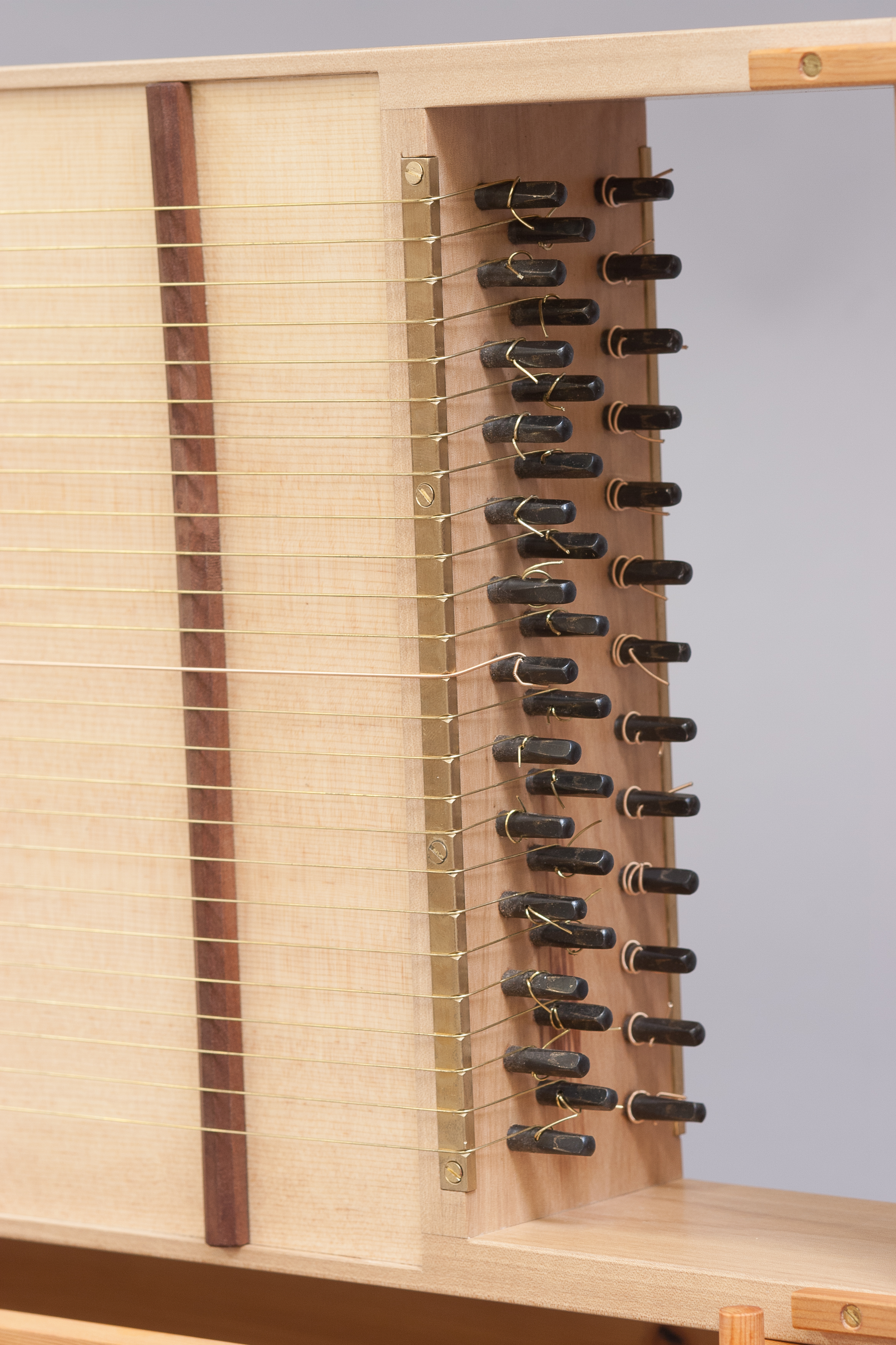 With 38 total strings, there's a lot of metal on the zither. Only the tuning pins and a few brass screws were not made in shop. Photos by David Welter