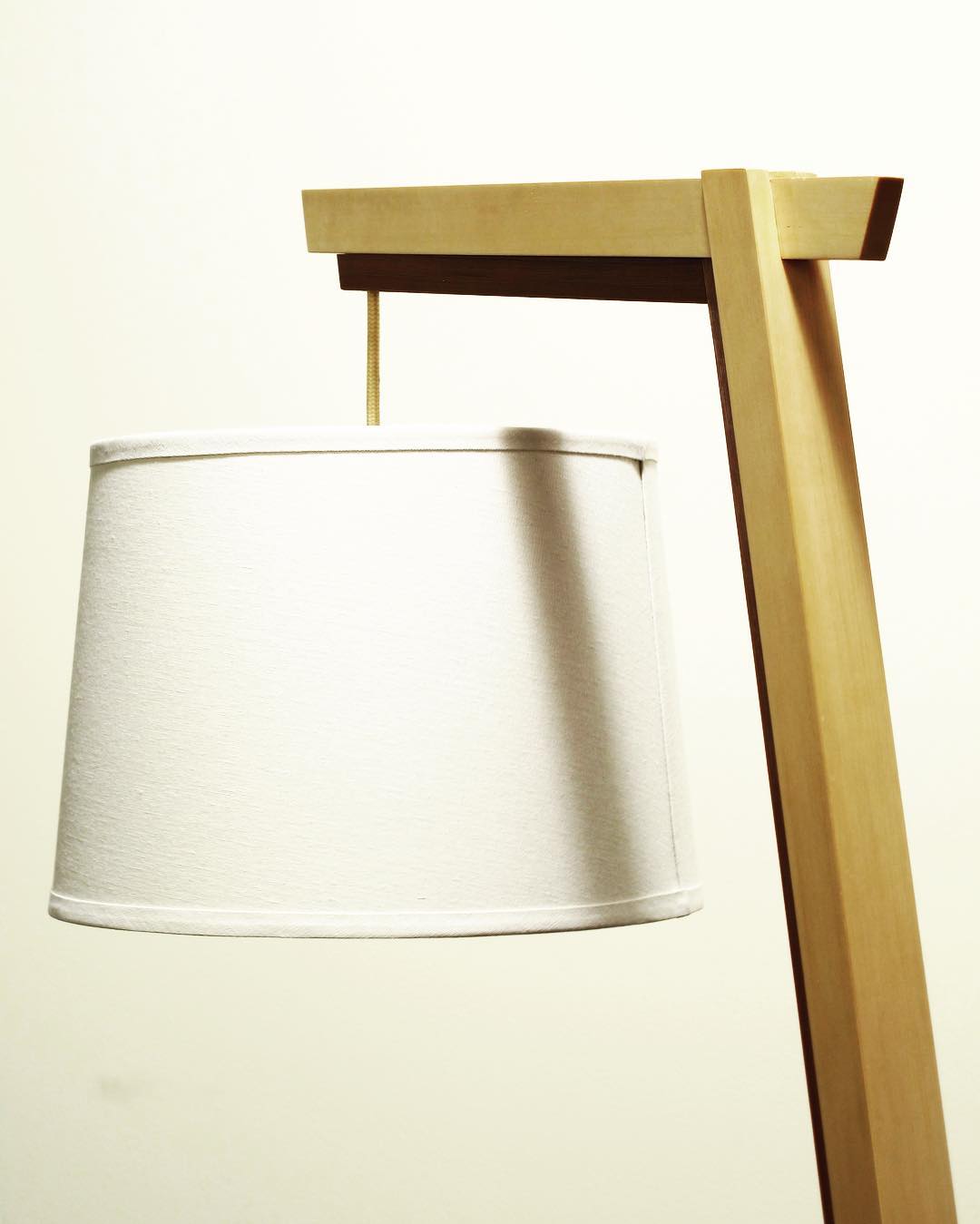 A lamp made from Alaskan yellow cedar and Burmese teak. The top joint was carefully cut by hand, and adds an elegant touch of joinery to an otherwise minimal design.