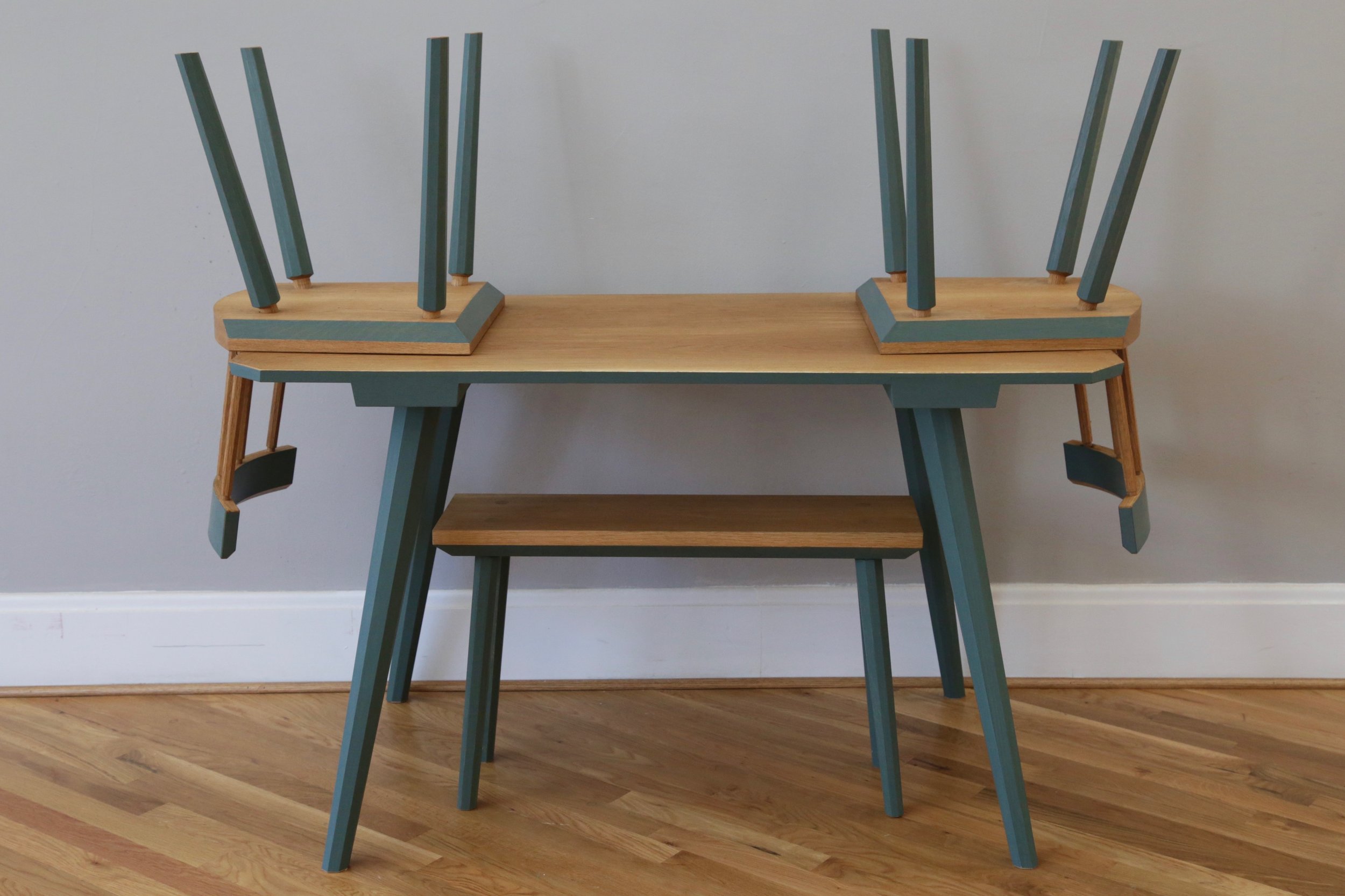 The set is made from white oak, with the legs of the bench and table in poplar. It was painted with traditional milk paint, and finished with Osmo hardwax oil.