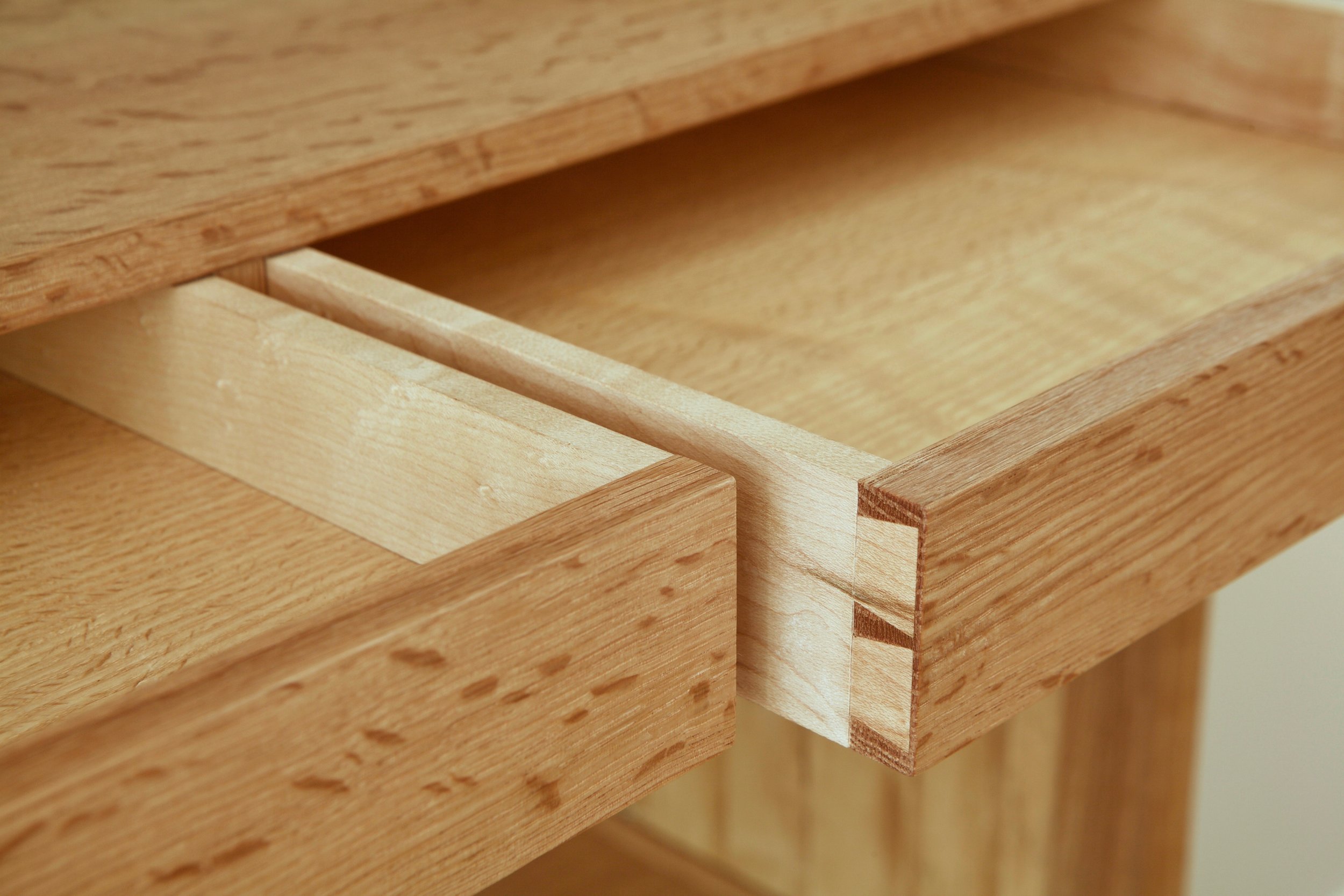 There is traditional and non-traditional joinery throughout the bookcase. While the drawers feature traditional hand-cut dovetails, the carcase was assembled with a combination of dowels, splines and floating tenons.