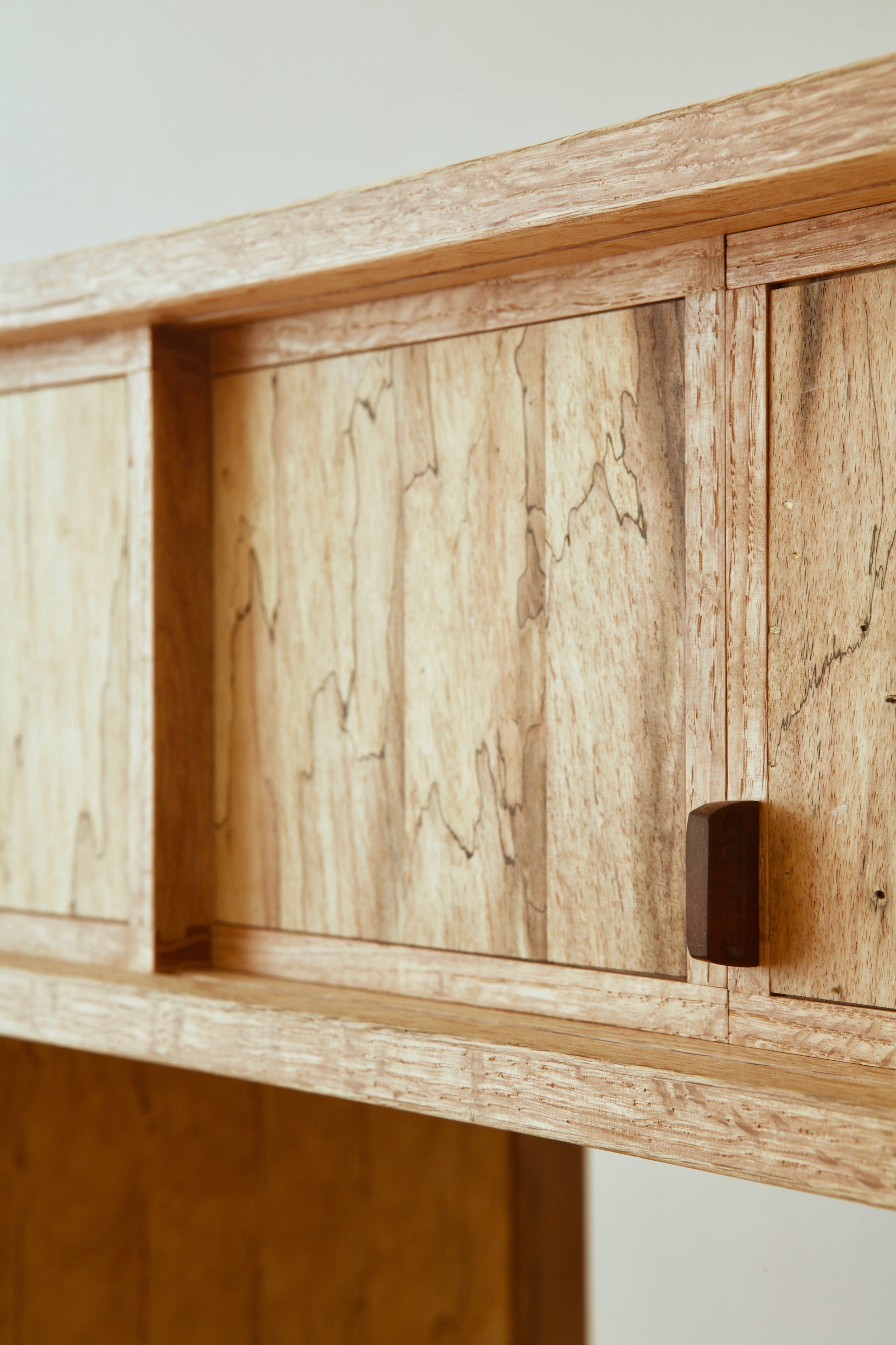 The pulls were carved with a knife from manzanita, a favorite hardwood of mine native to the west coast. This dense maroon wood carves beautifully and holds the knifed facets perfectly.