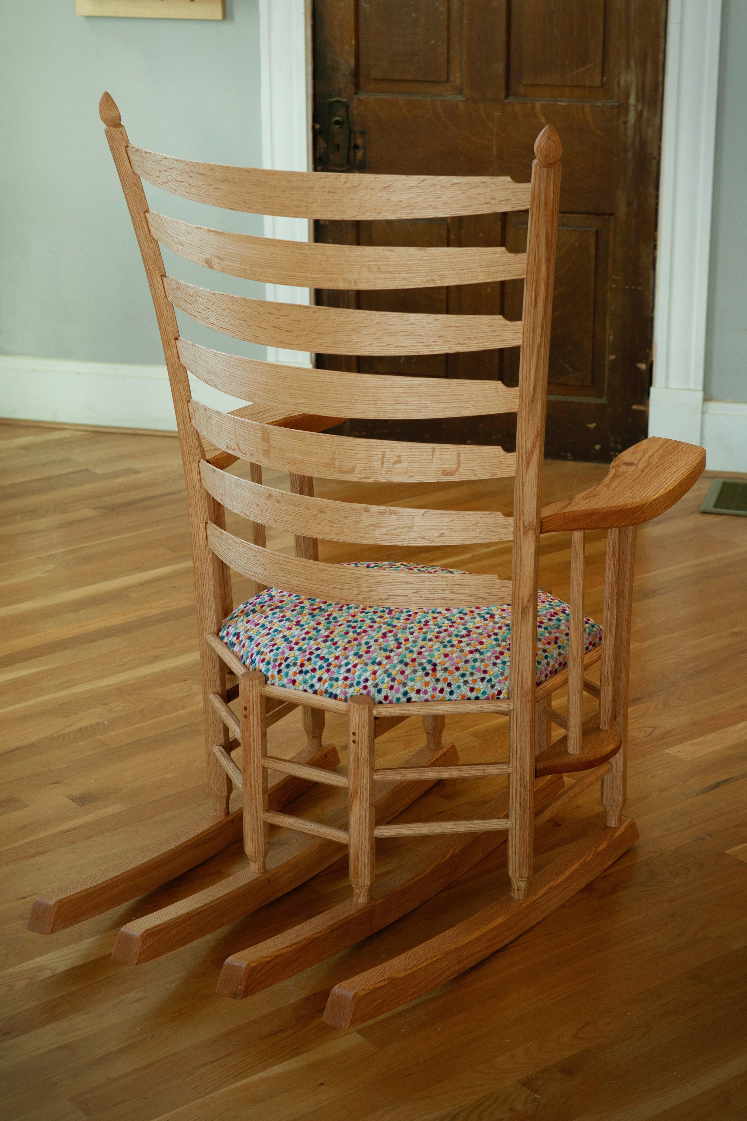 Cornett’s designs often feature a repetition of eight in the geometric form. All elements of this piece are eight-sided, and there are eight posts, four rockers, and 48 individual pieces that make up the structure of the piece.