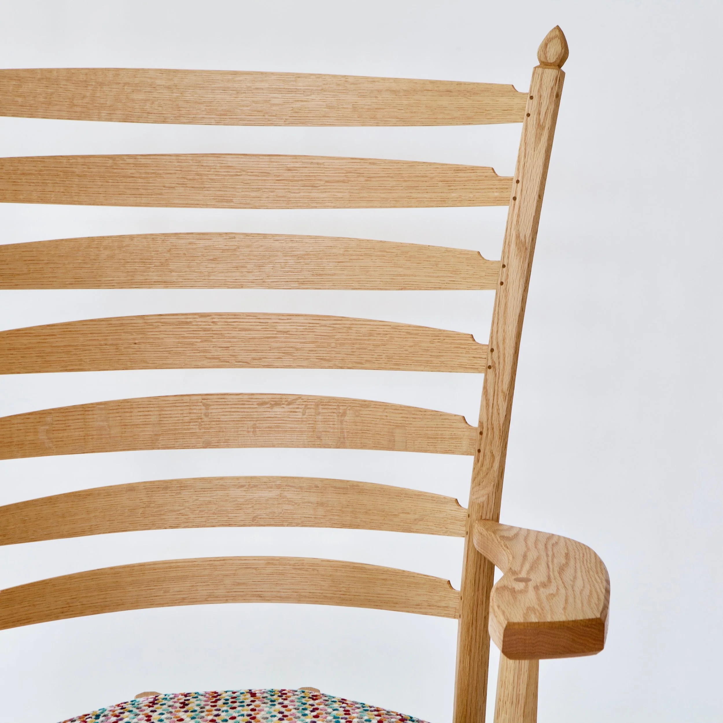  The seven slats are steambent and fit in place, rived and shaved from the same log as the rest of the piece. 