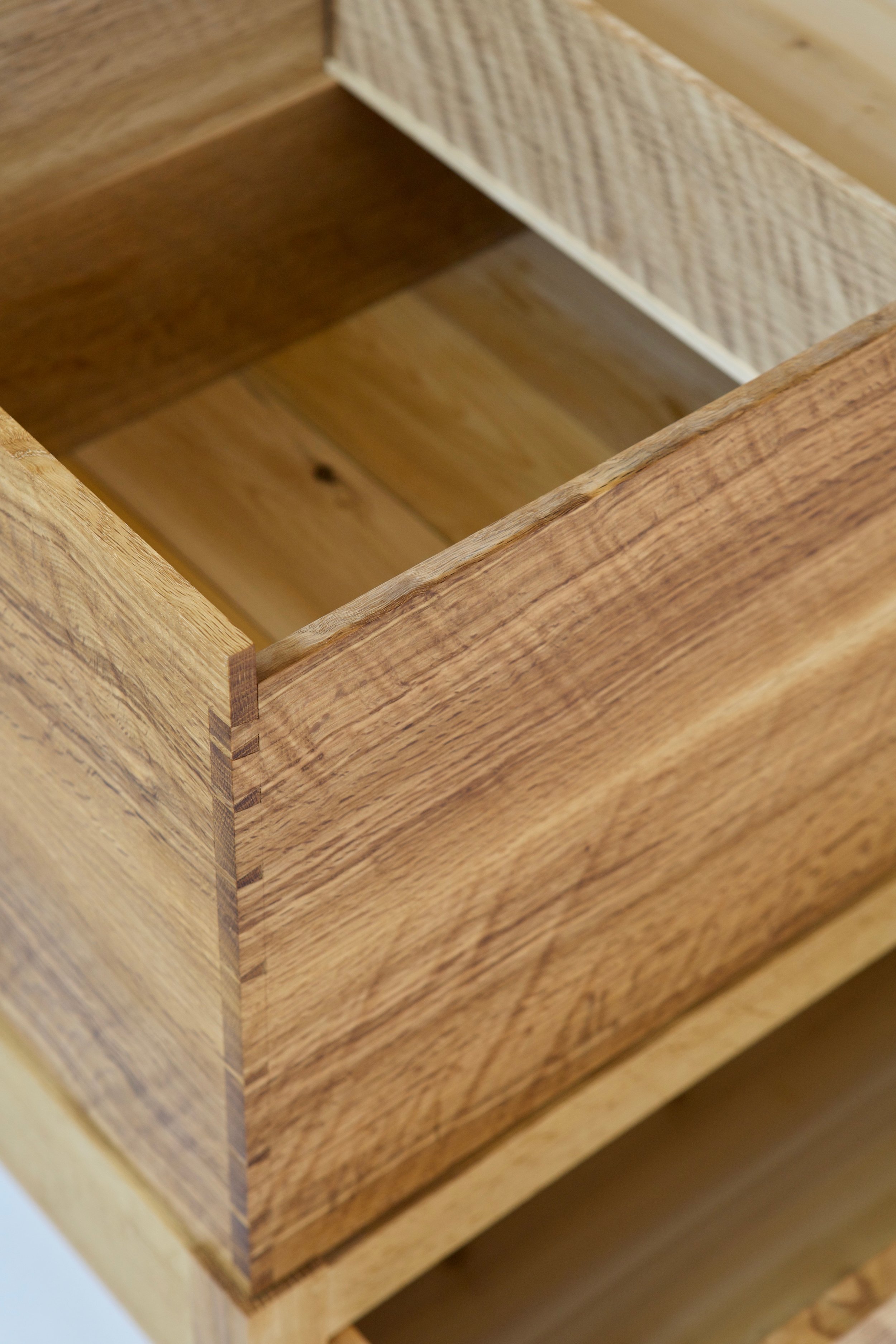  The interior of the chest has a simple sliding till, which are evidence of the influence this chest finds in the classic tool chest. The till slides on internal rails, and is made with the same curly oak as the carcase. 