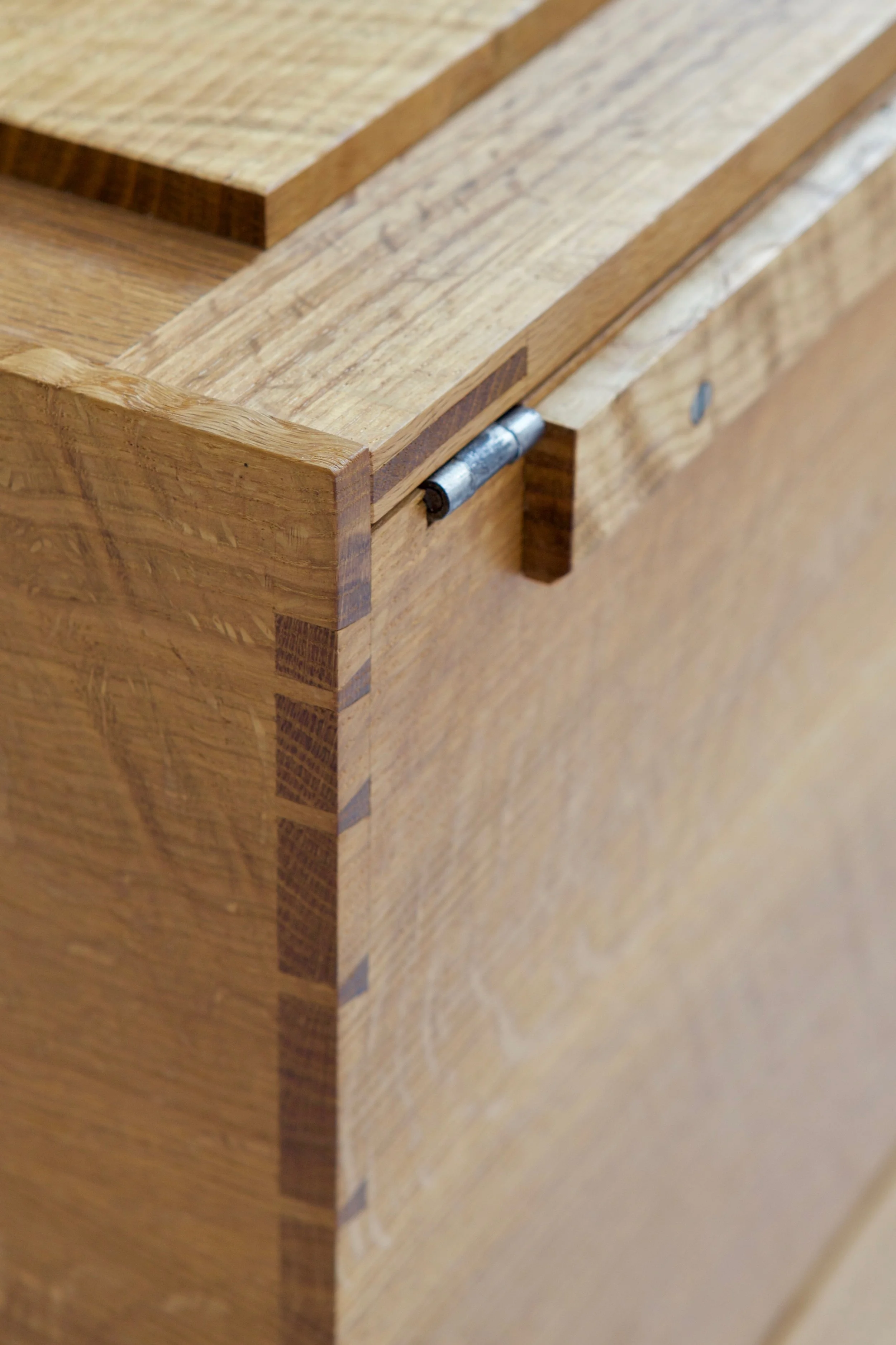  A main focus of this piece was to let the straightforward construction and joinery shine by resisting significant ornament. Here, the bridle joint and raised panel that comprise the lid, the carcase dovetails and the simple lid stay at the back of t