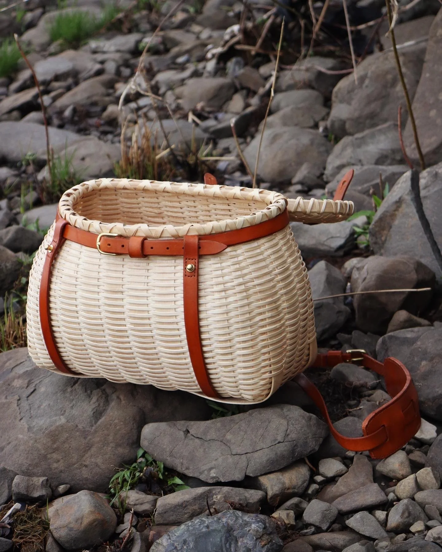  Fashioned after a traditional creel form, this basket is made with white ash splint, white oak trimmings and custom leatherwork. 
