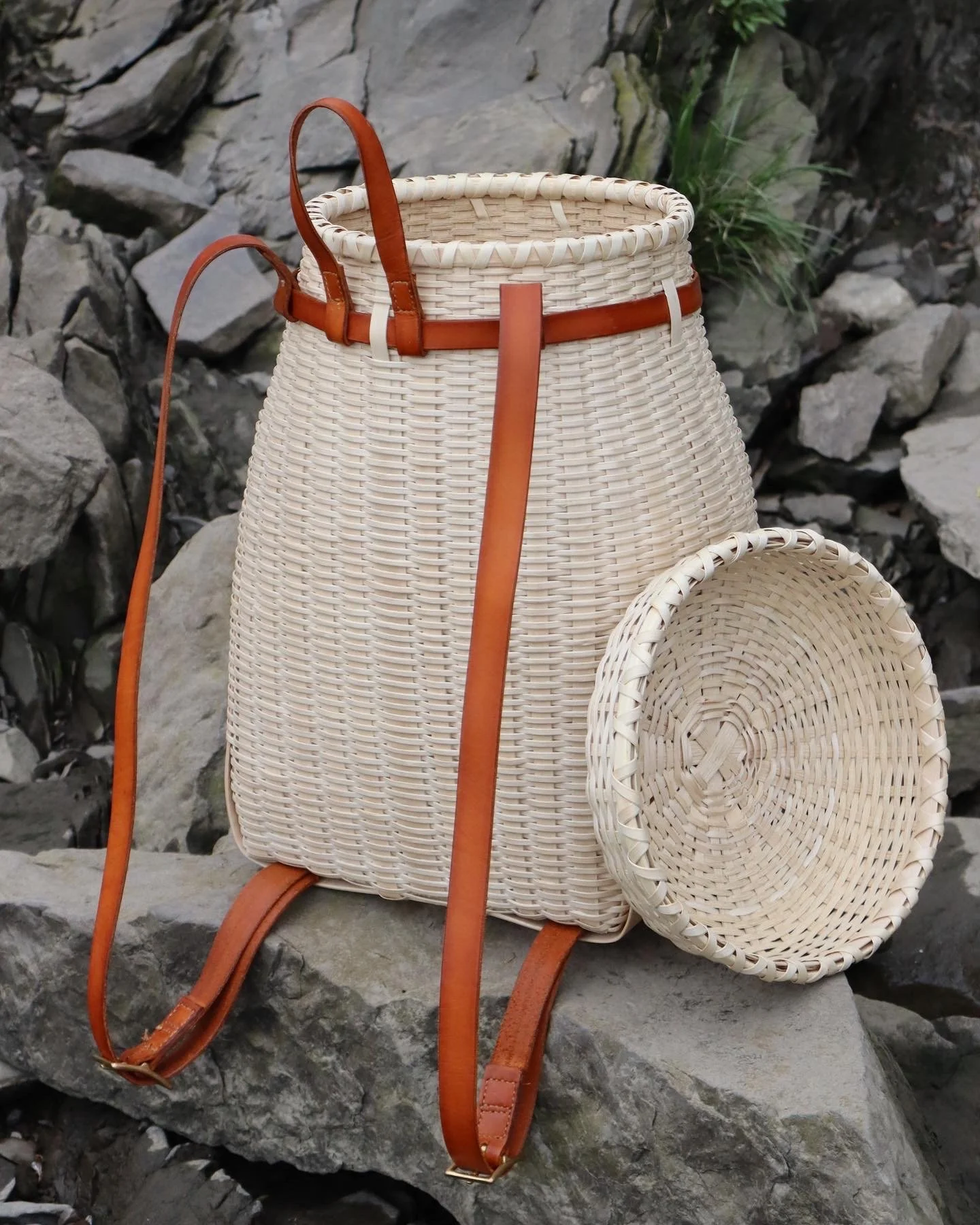  A traditional pack basket, with a carefully shaped form made entirely from ash and custom stitched and dyed leather made in house. 