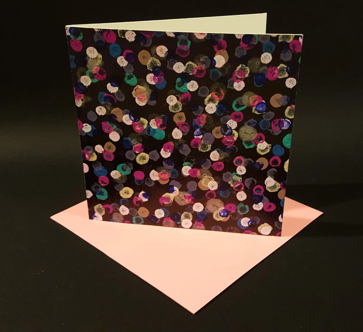  Multi-colored imperfect dots on a painted background 