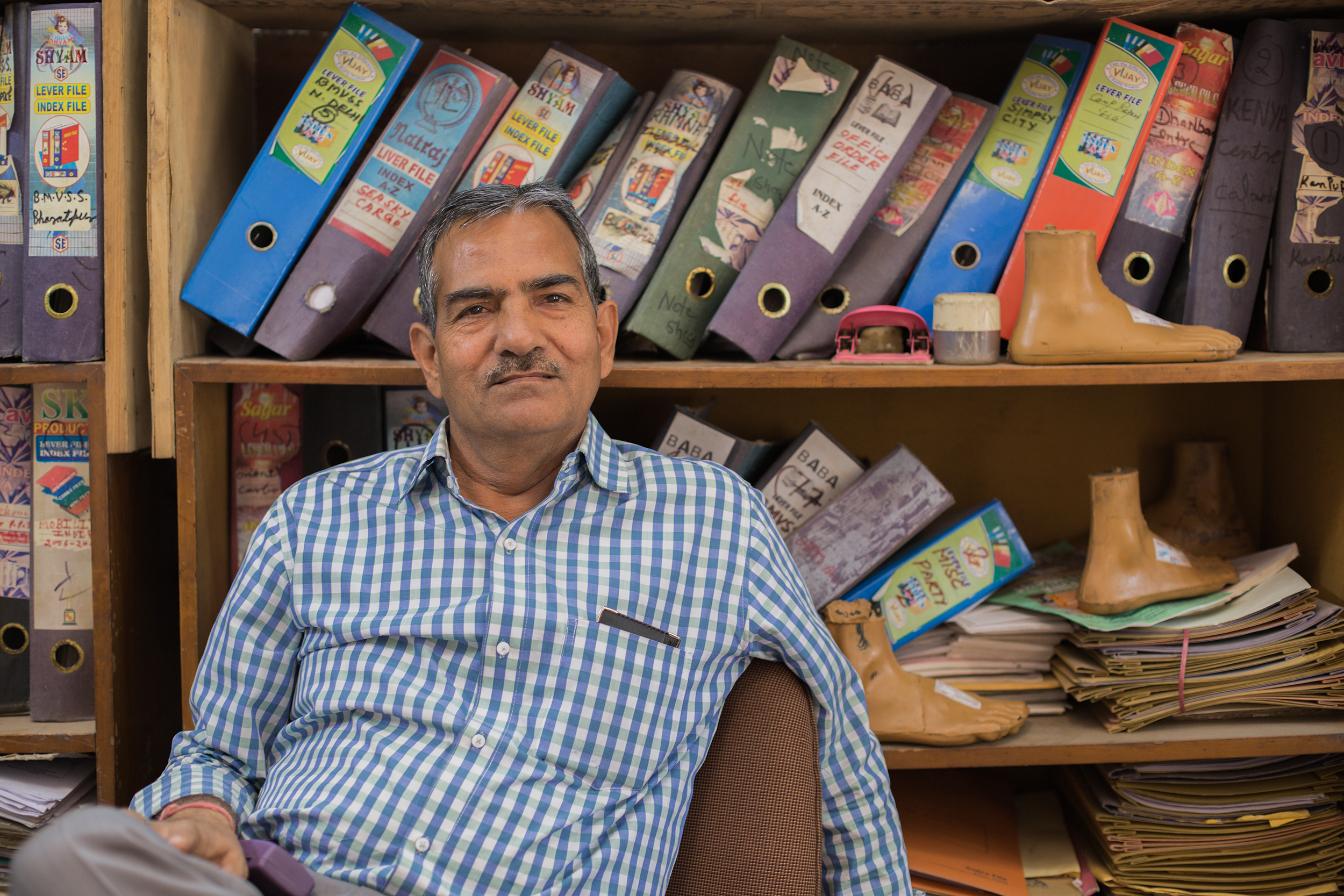 The manager, Om Prakash Sharma in the main BMVSS office in Jaipur, India.