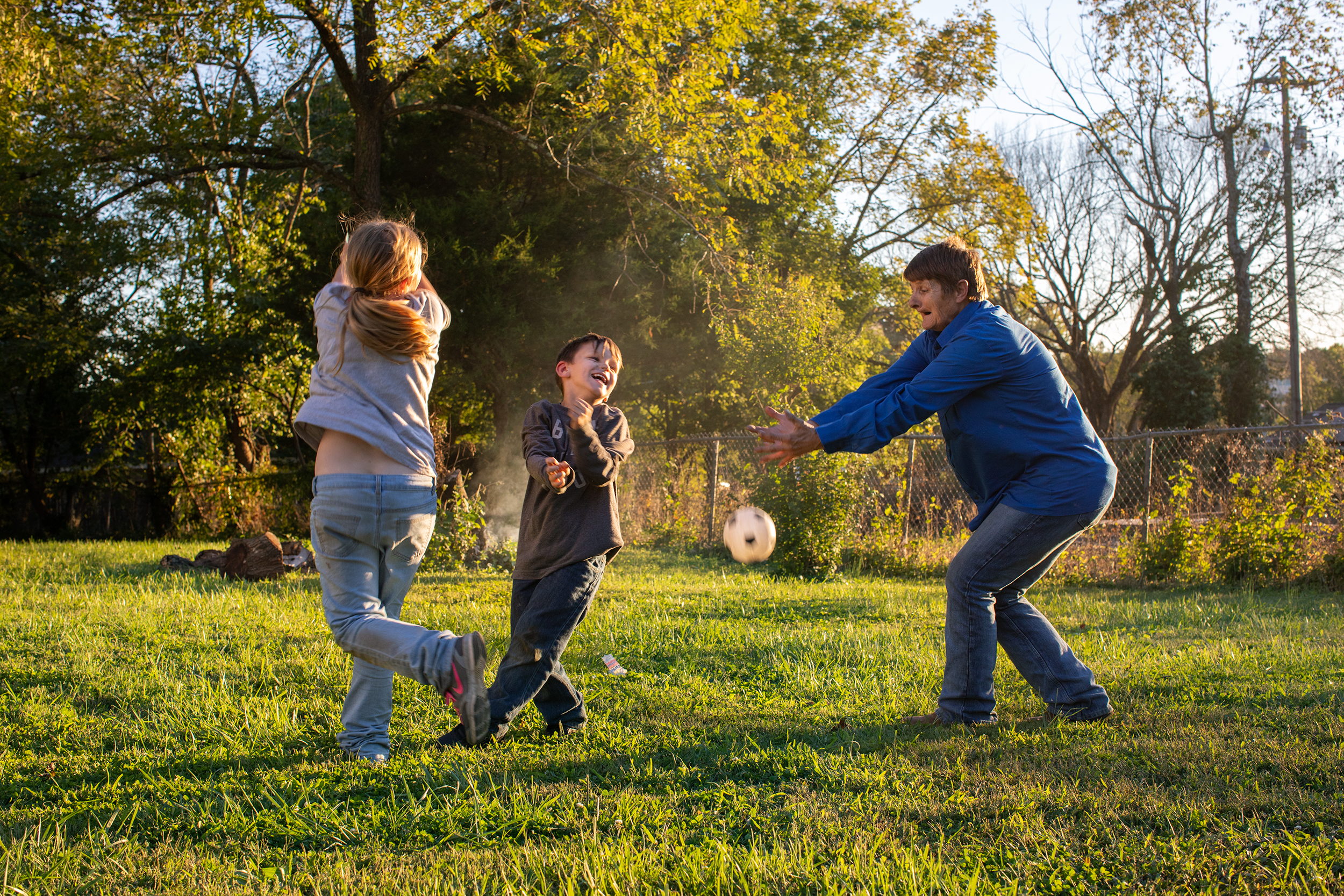  Brenda plays with her grandson, Jonathan, and her grandniece, Grace, in their yard in Mountain Grove, Mo. 