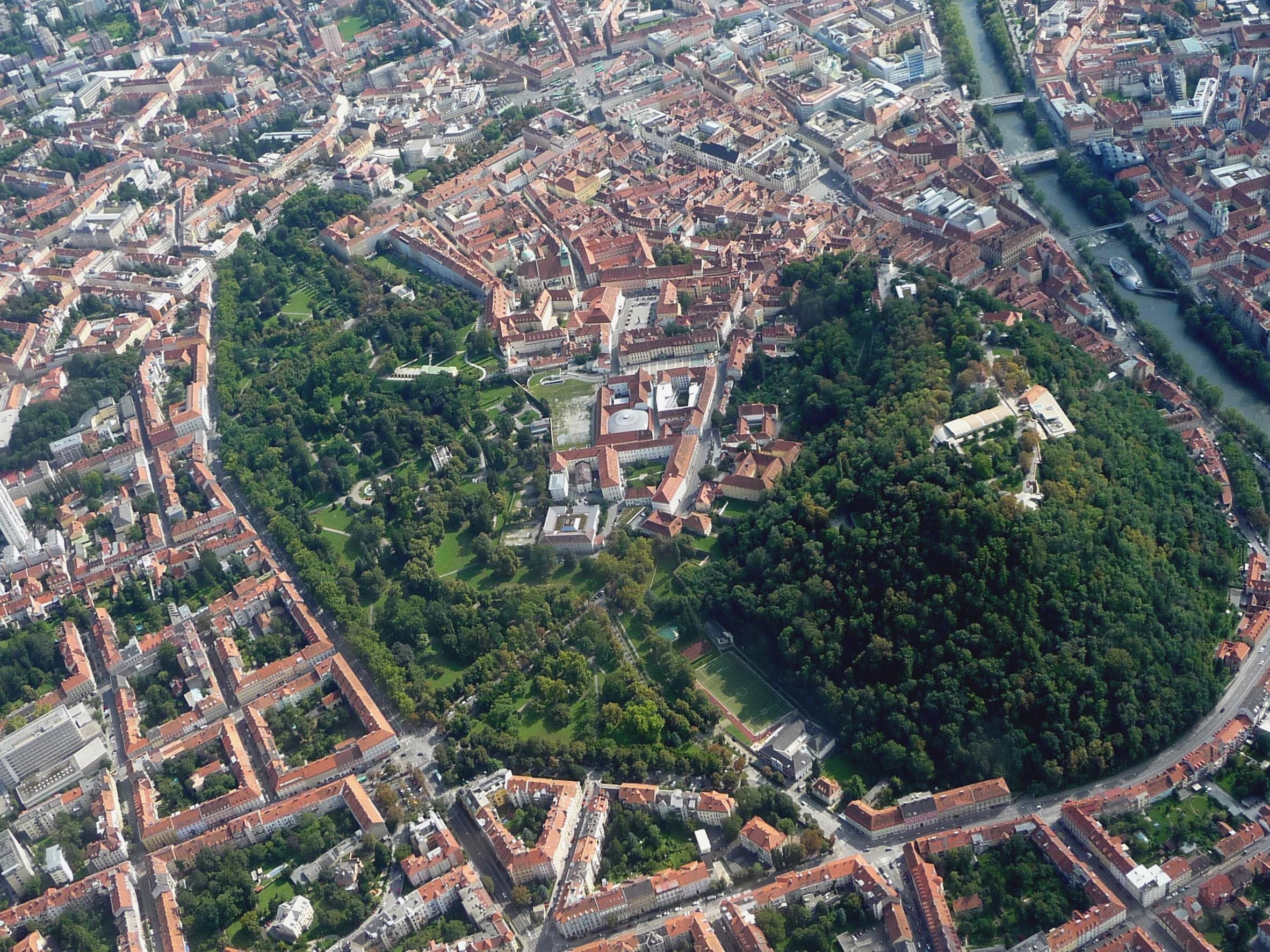 Graz from the air. Green areas of Schlossberg, the Stadt Park and the private inner courtyards.