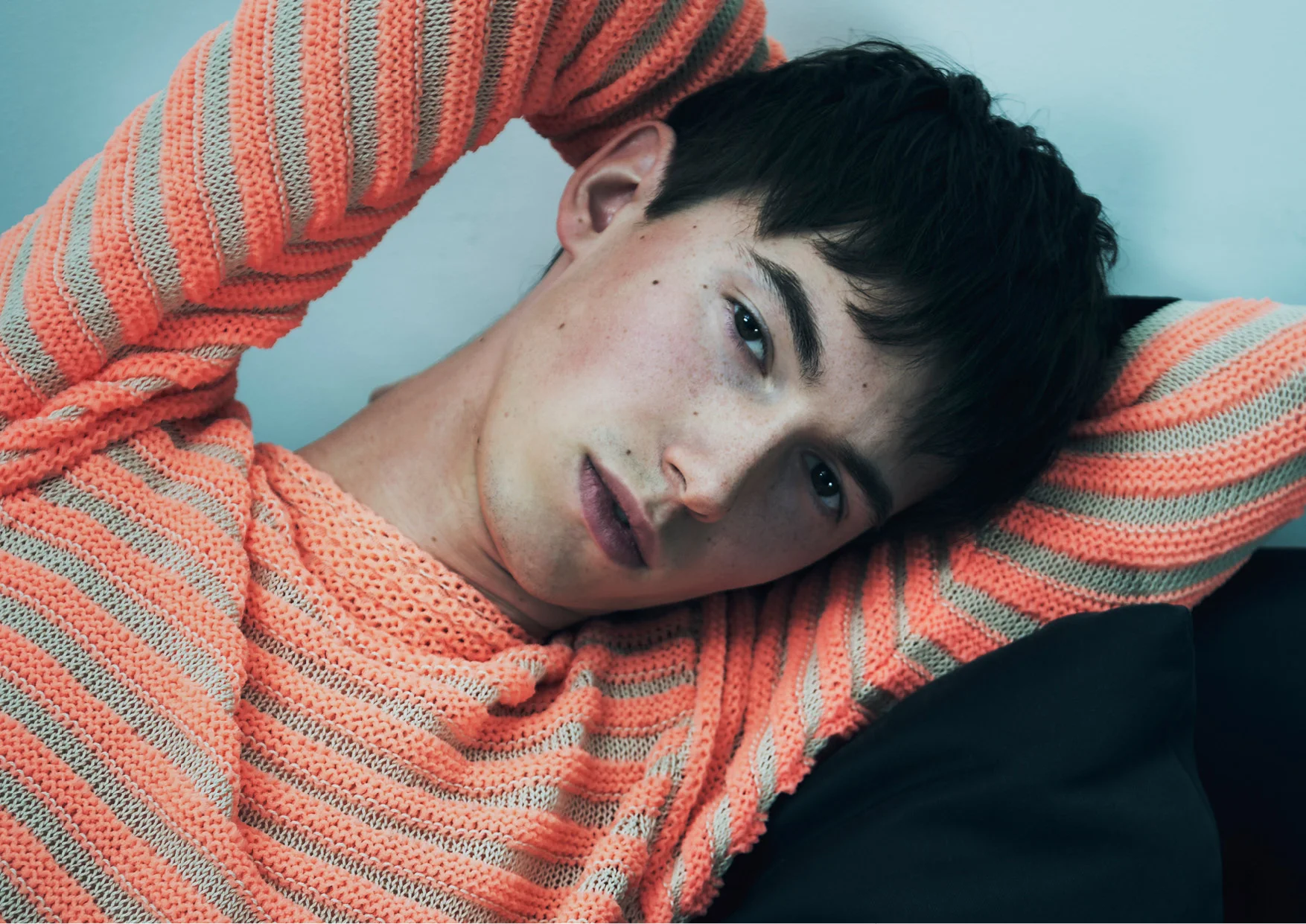 Tyas wears a jumper by PAUL SMITH