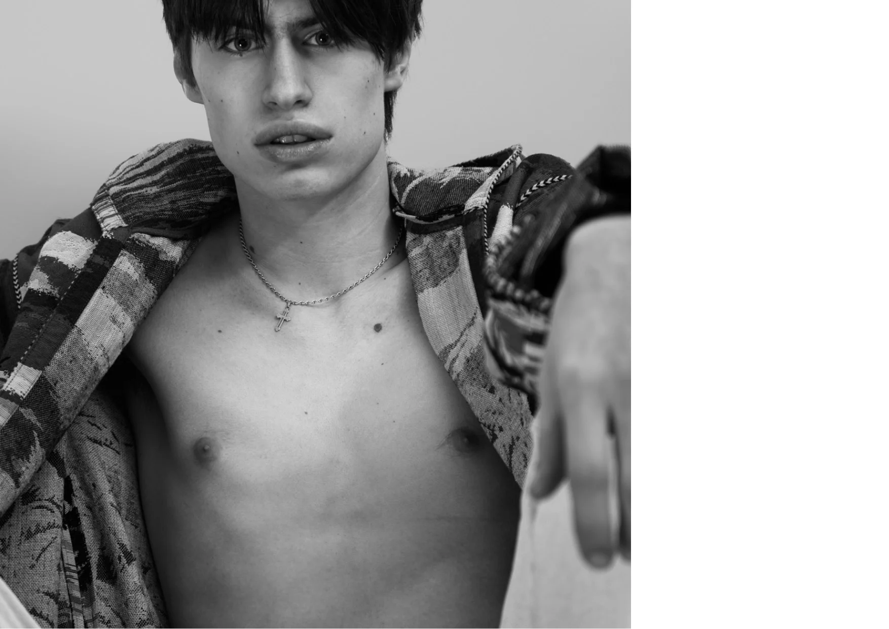 Bo wears a jacket & necklace by SAINT LAURENT