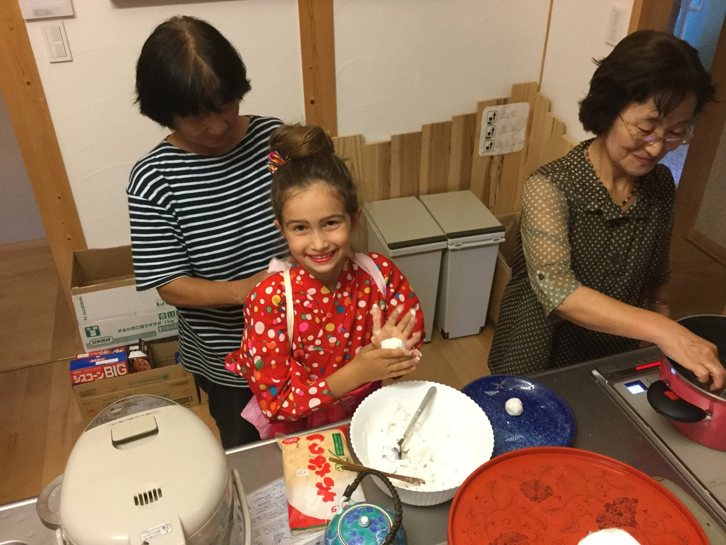 Have an assistant tie your kimono sleeves back so they don't get messy. Have other assistant start cooking dango balls by dumping them into boiling water.