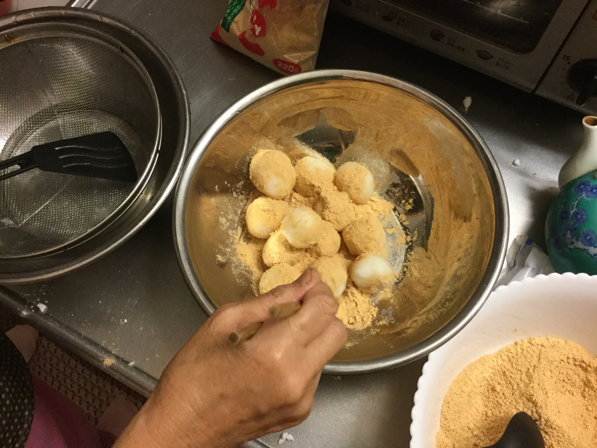 Then roll the cooked wet balls in bean powder mix
