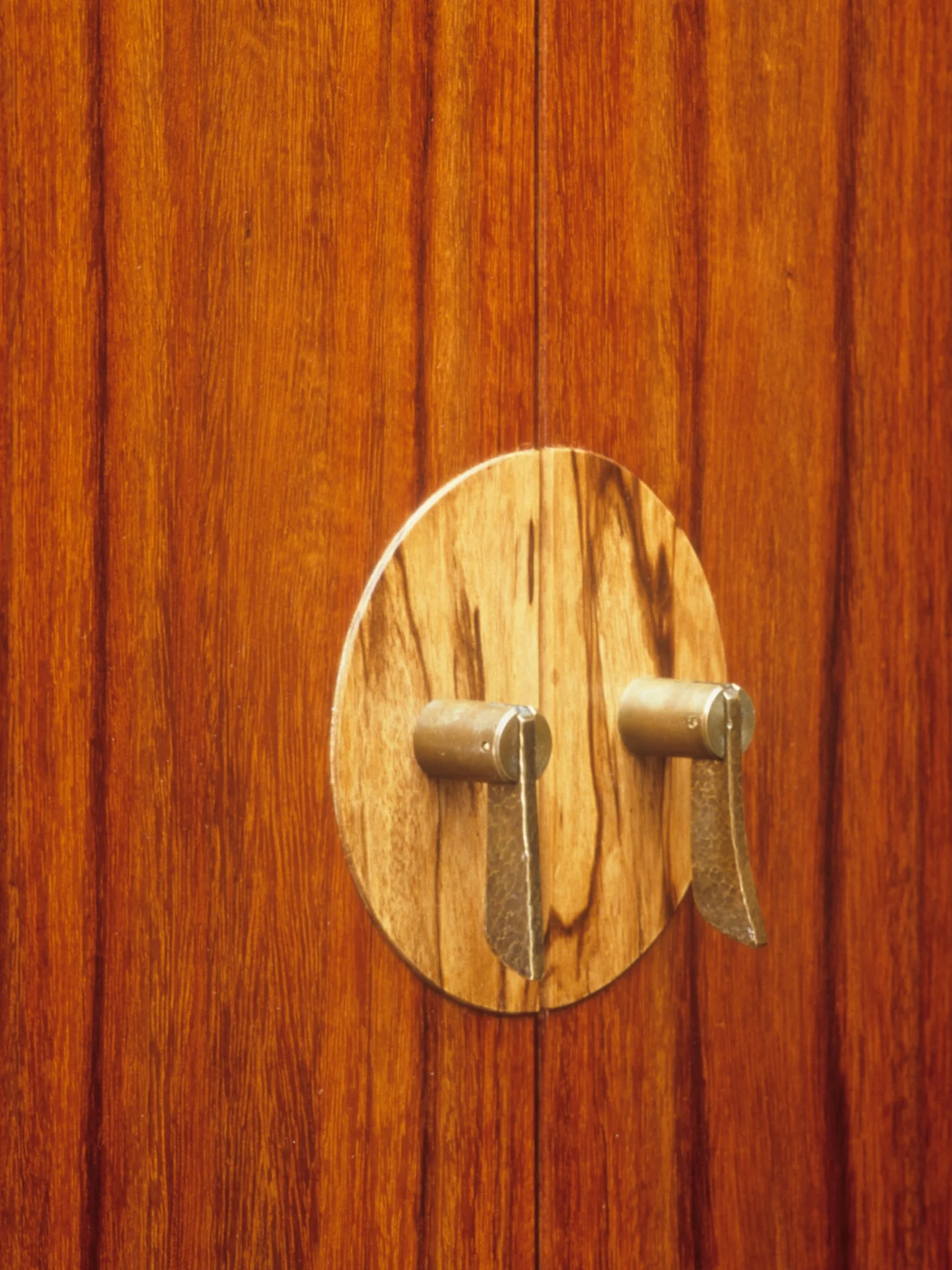 Hand-shaped and patinated brass drop pulls