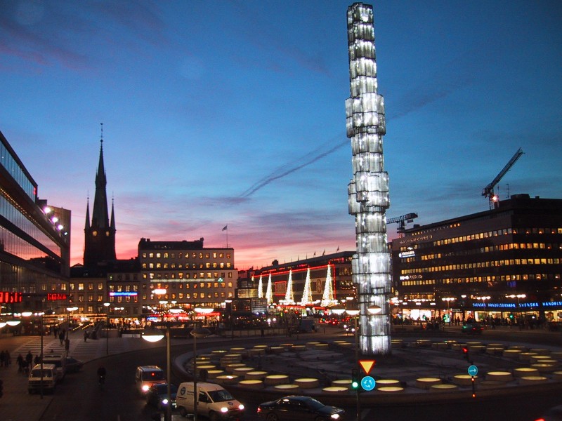 Stockholm City Center with Ahlens Shopping Mall (triangle lights and red trim). Photo Credit: dorothytours.se
