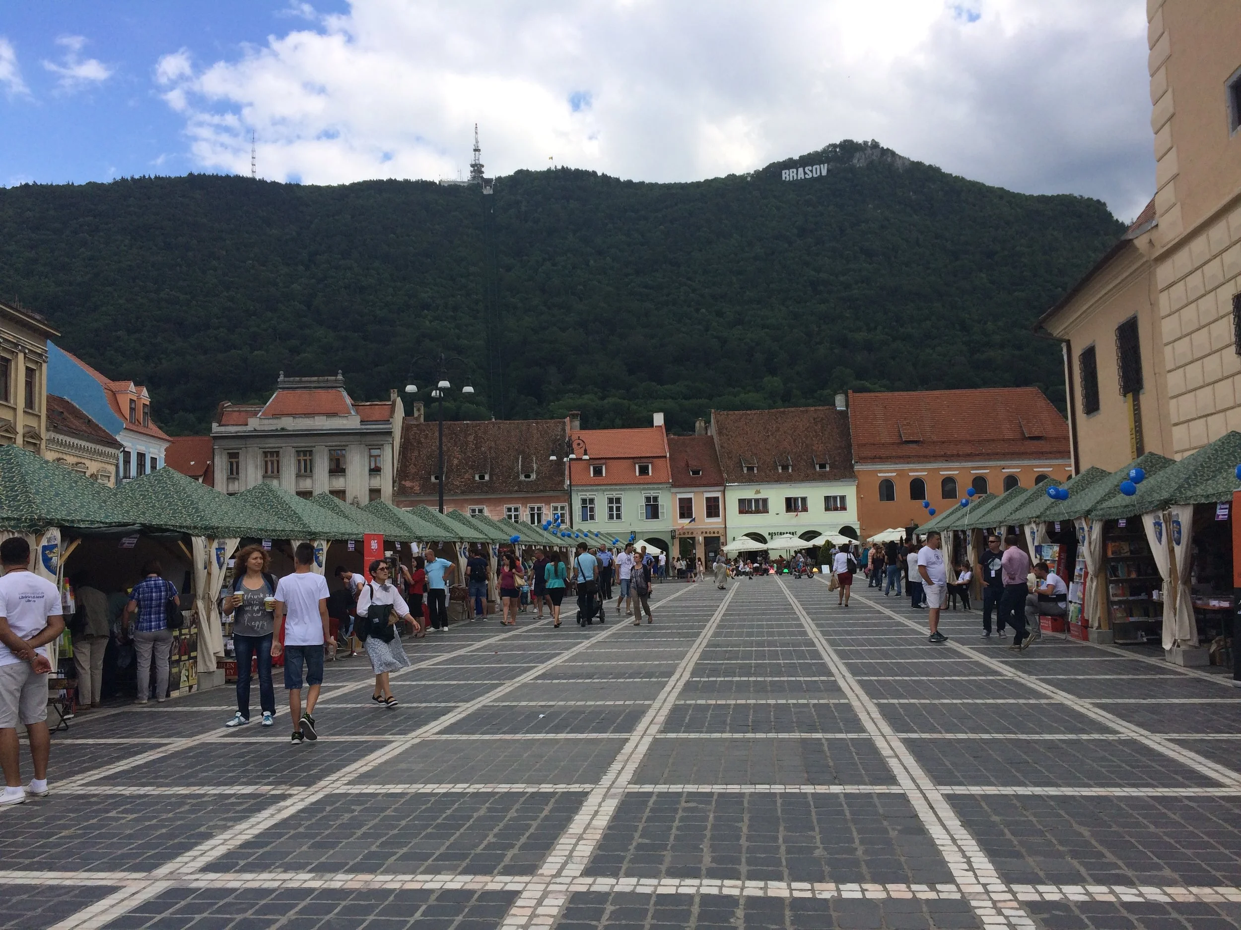 Vendors sell goods in the town square at the foot of Mount Tampa