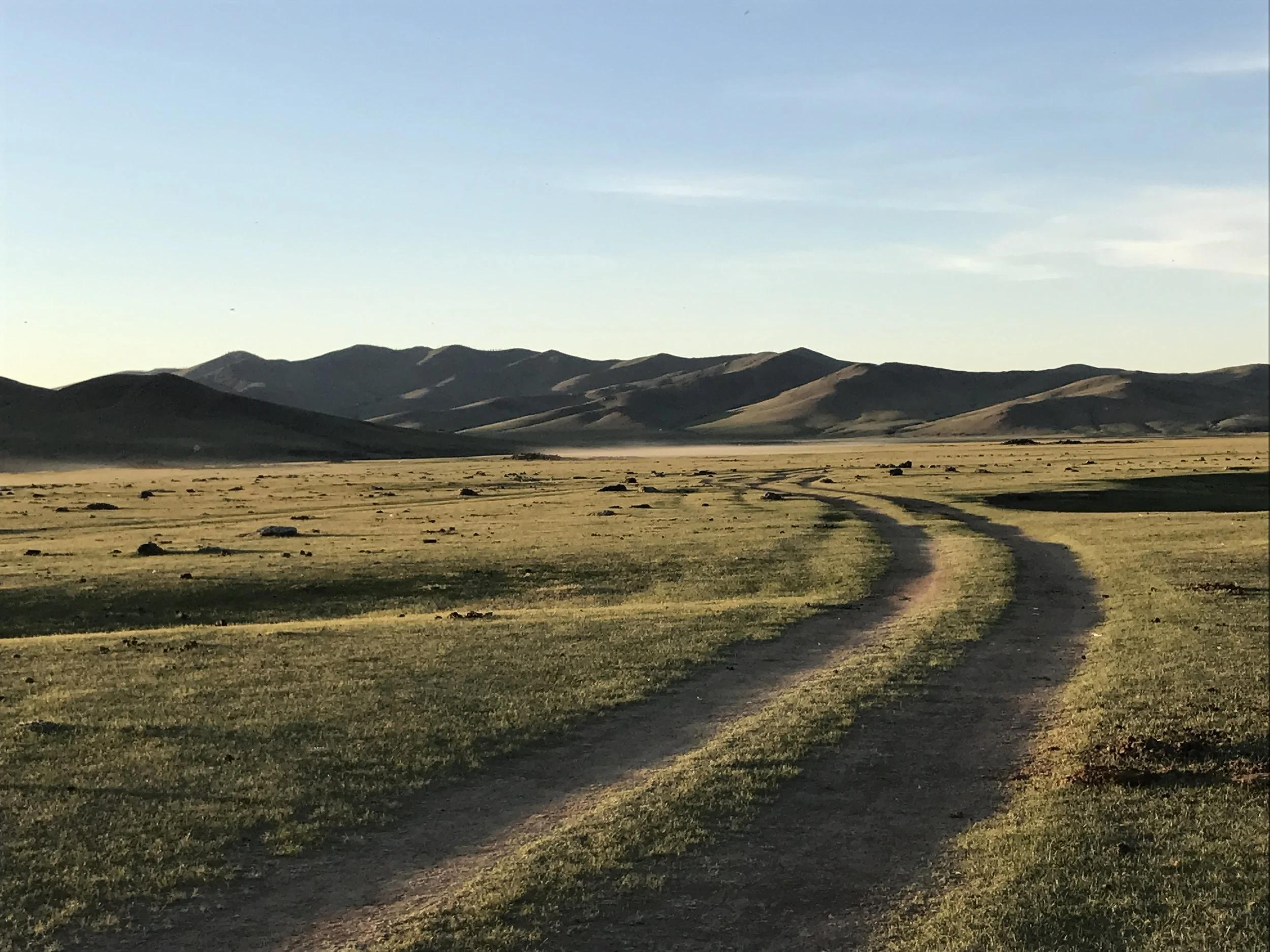 Sunset after a warm day on the steppe. We drove on a road like this through a volcanic rock field for two hours.