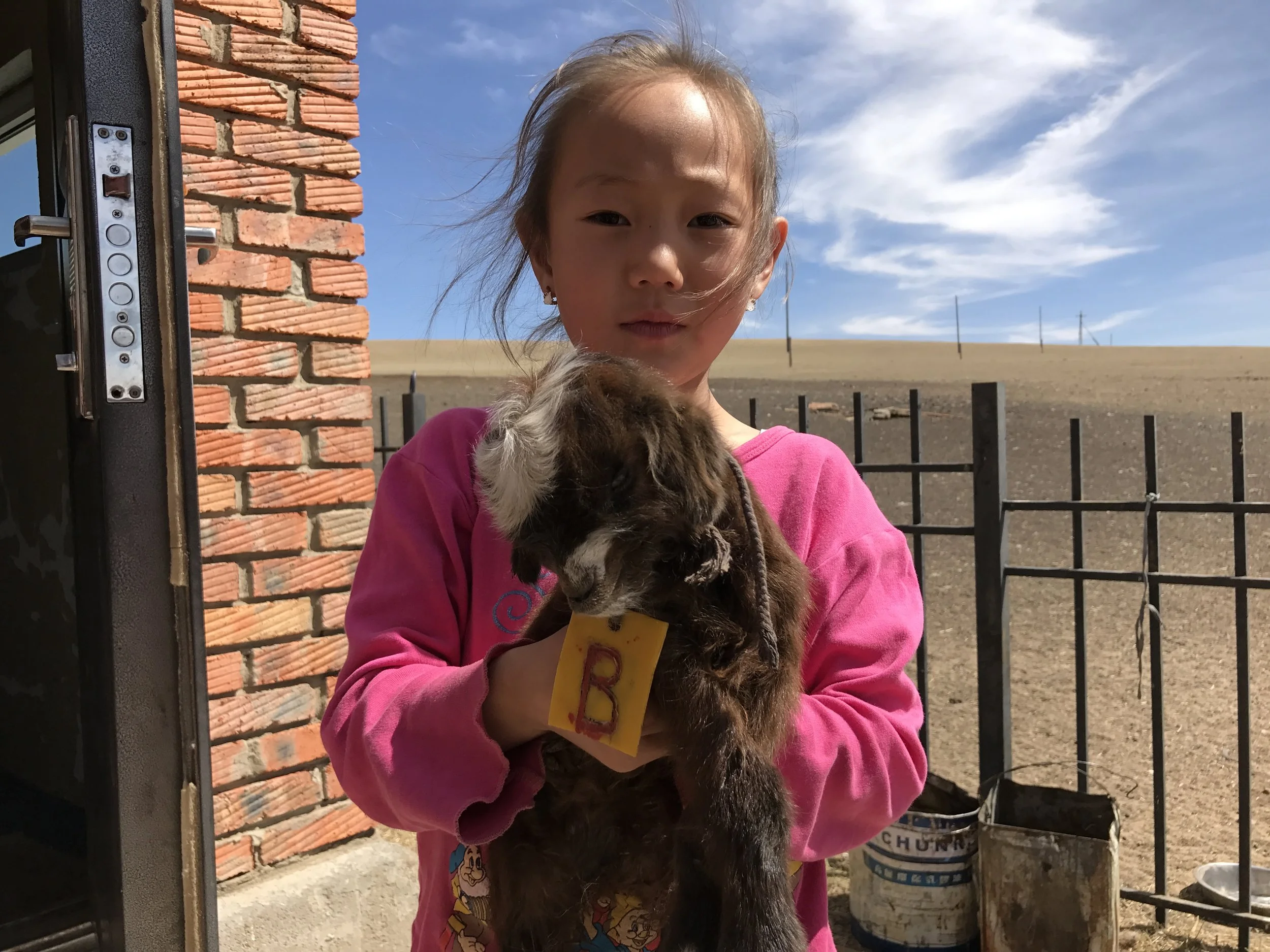 The child of a host shows off her baby goat