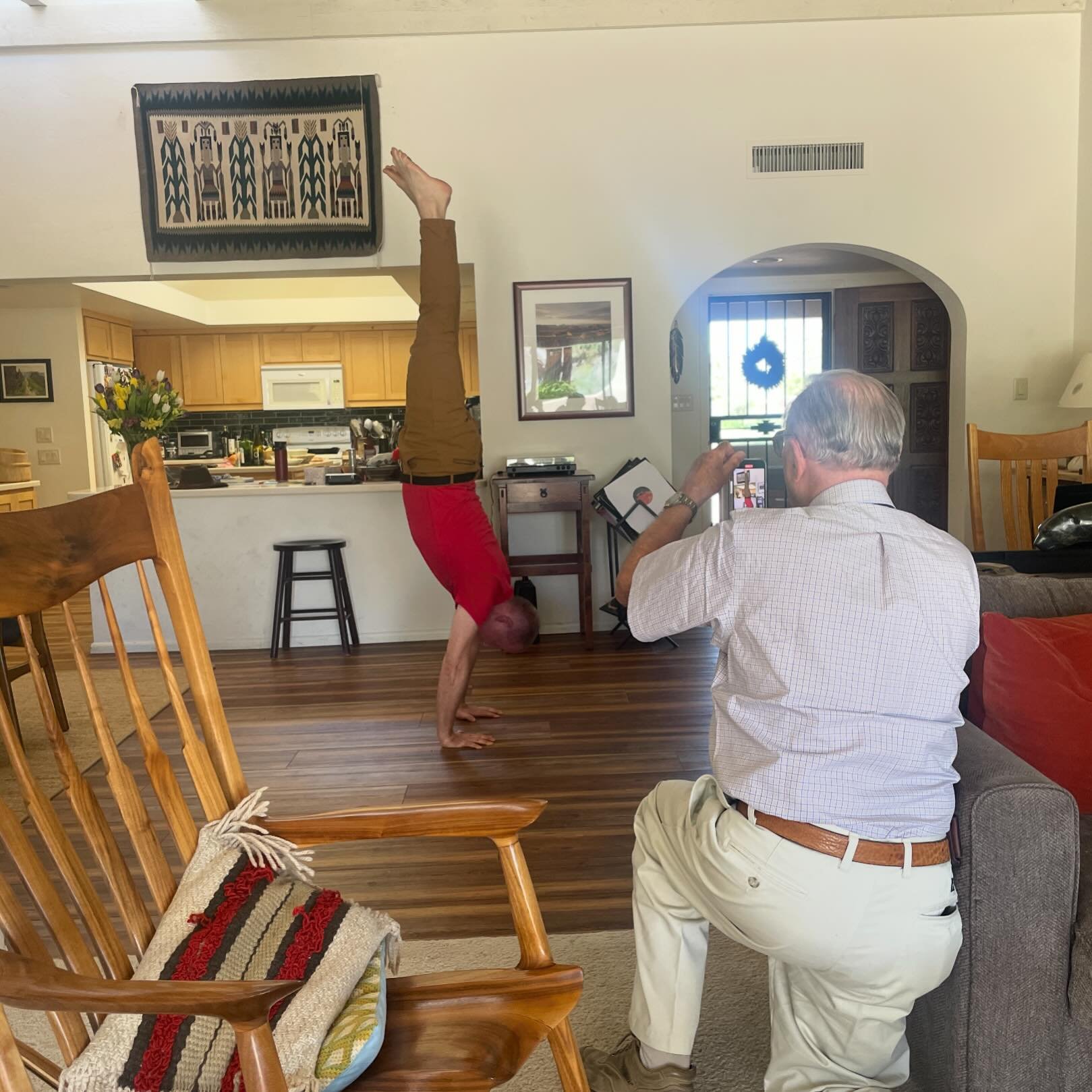 Dad videoing my brother doing a handstand