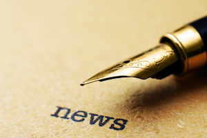 Fountain pen on news text