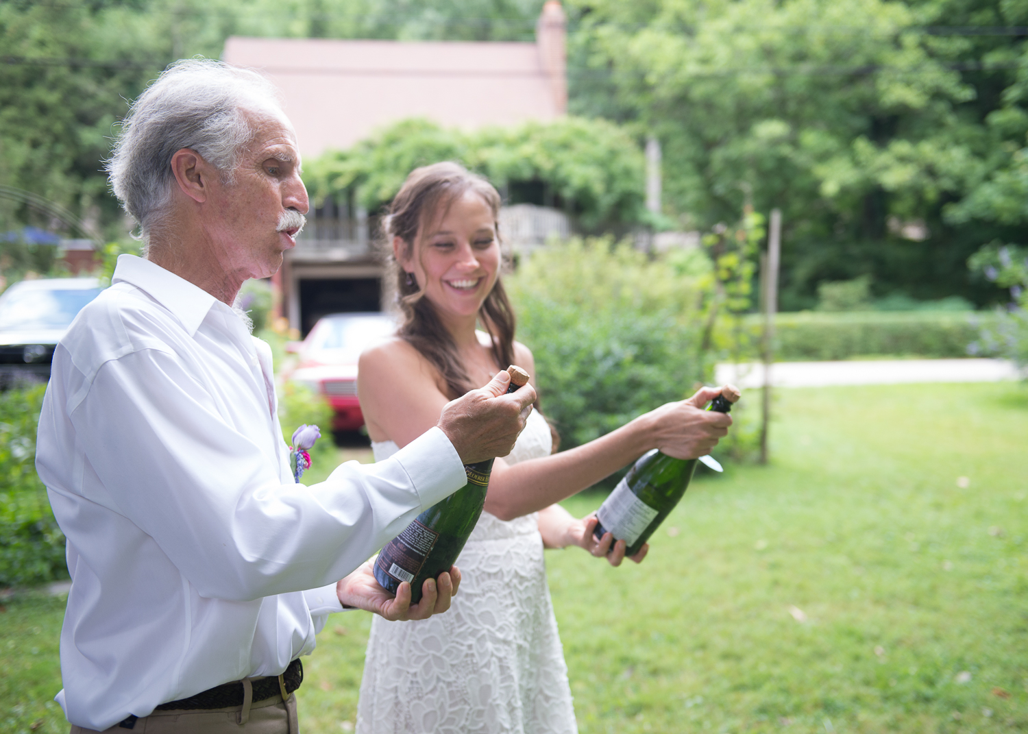 Aaron's dad, Joe, teaches Ada how to open a bottle of champagne.