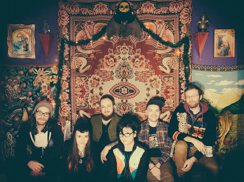 Left to right: Lucas Carine (drums, toy piano, glockenspiel, voice), Aubrey VanVliet (bass guitar, voice), Fletcher VanVliet (guitars, mandolin, voice), Evan McGonagill (cello, voice), Robin Carine (guitars, voice), and Jesse Sparhawk (harp, banjo)