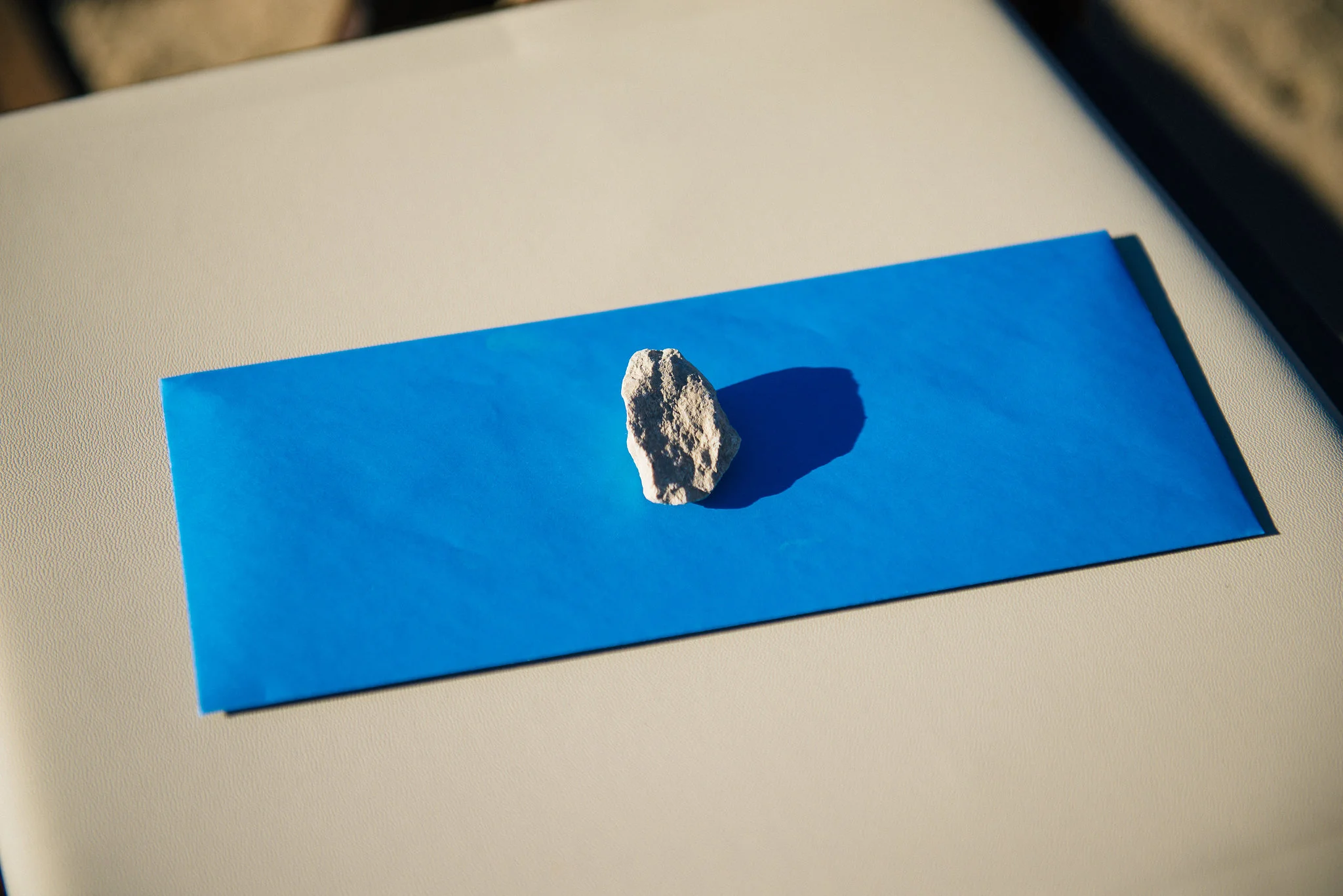 Freddie's nieces came up with the idea to place small desert rocks on top of the programs.