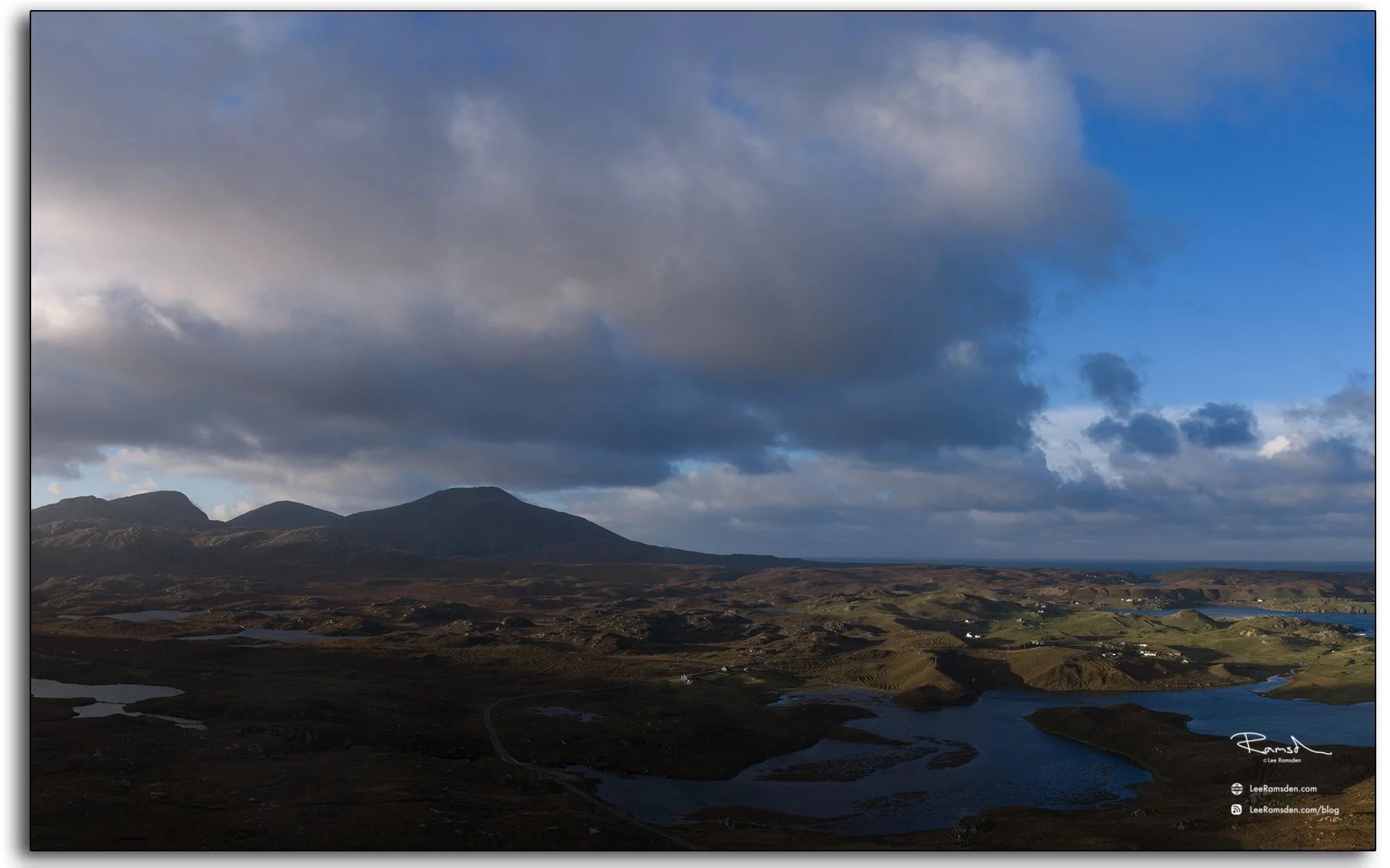 Moody landscape view over Uig Sands and the Isle of Lewis, Outer Hebrides, with dark clouds and soft evening light