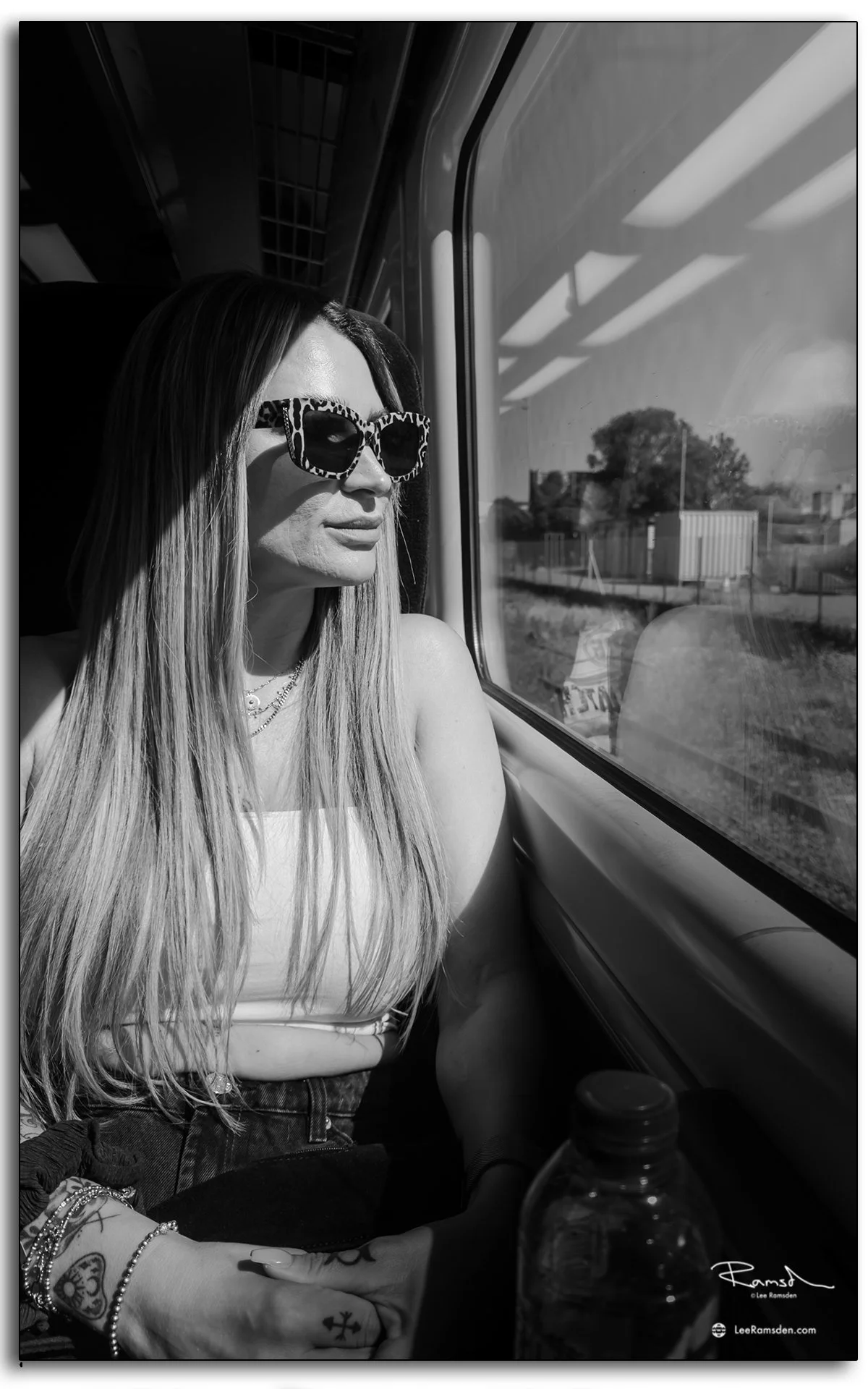 Festival-goer on train journey to TRNSMT Festival, photographed in black and white.