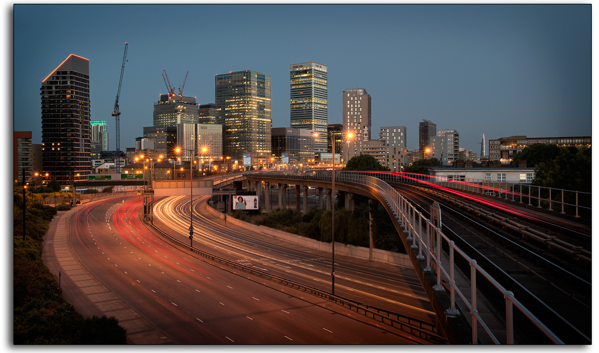 boarder 02 light trails Canary Wharf tram train cars dusk dawn cranes long exposure london landscape lee ramsden art professional photographer www.leeramsden.com.jpg