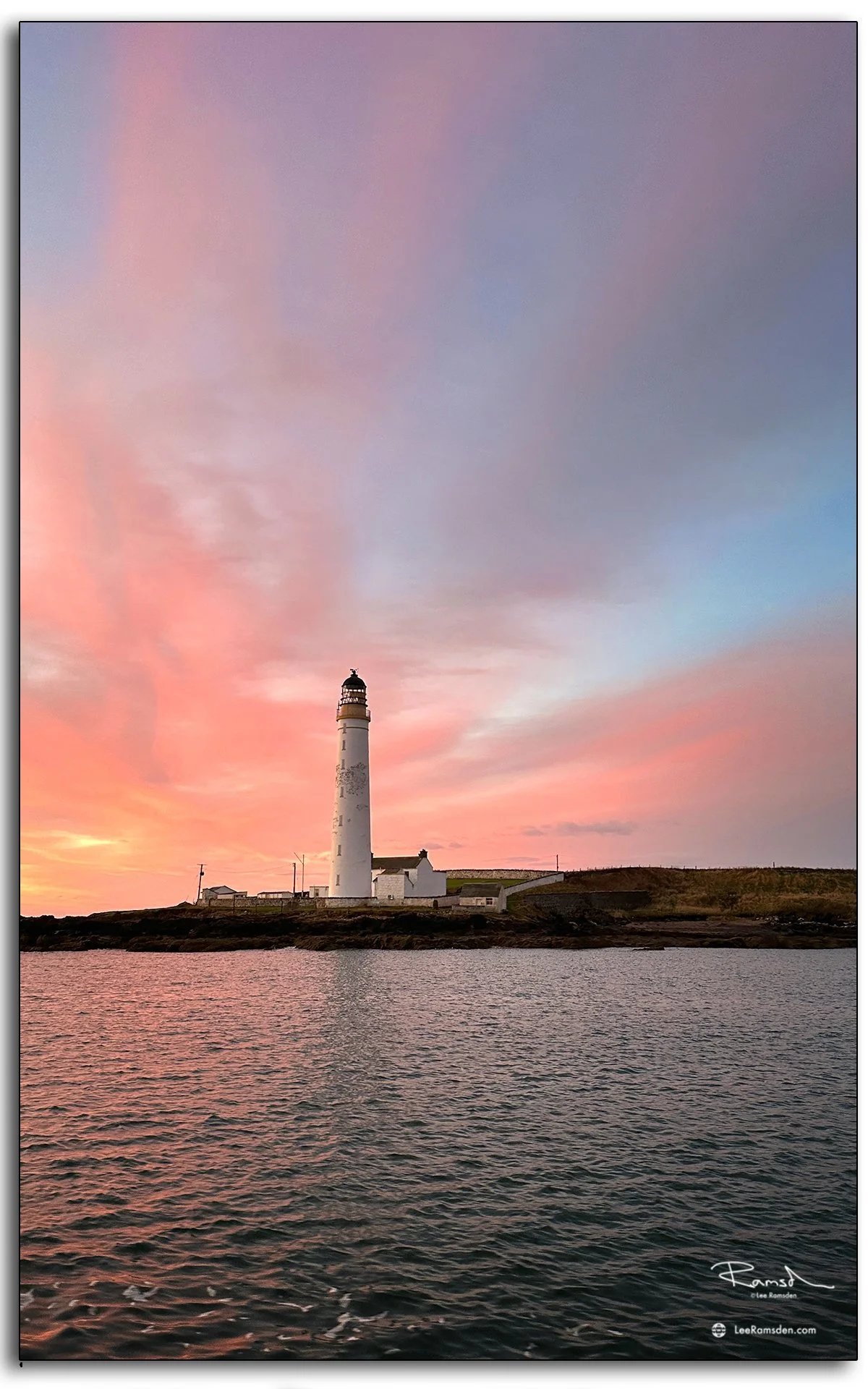 Scurdie Ness Lighthouse against pastel pink dusk sky in Montrose