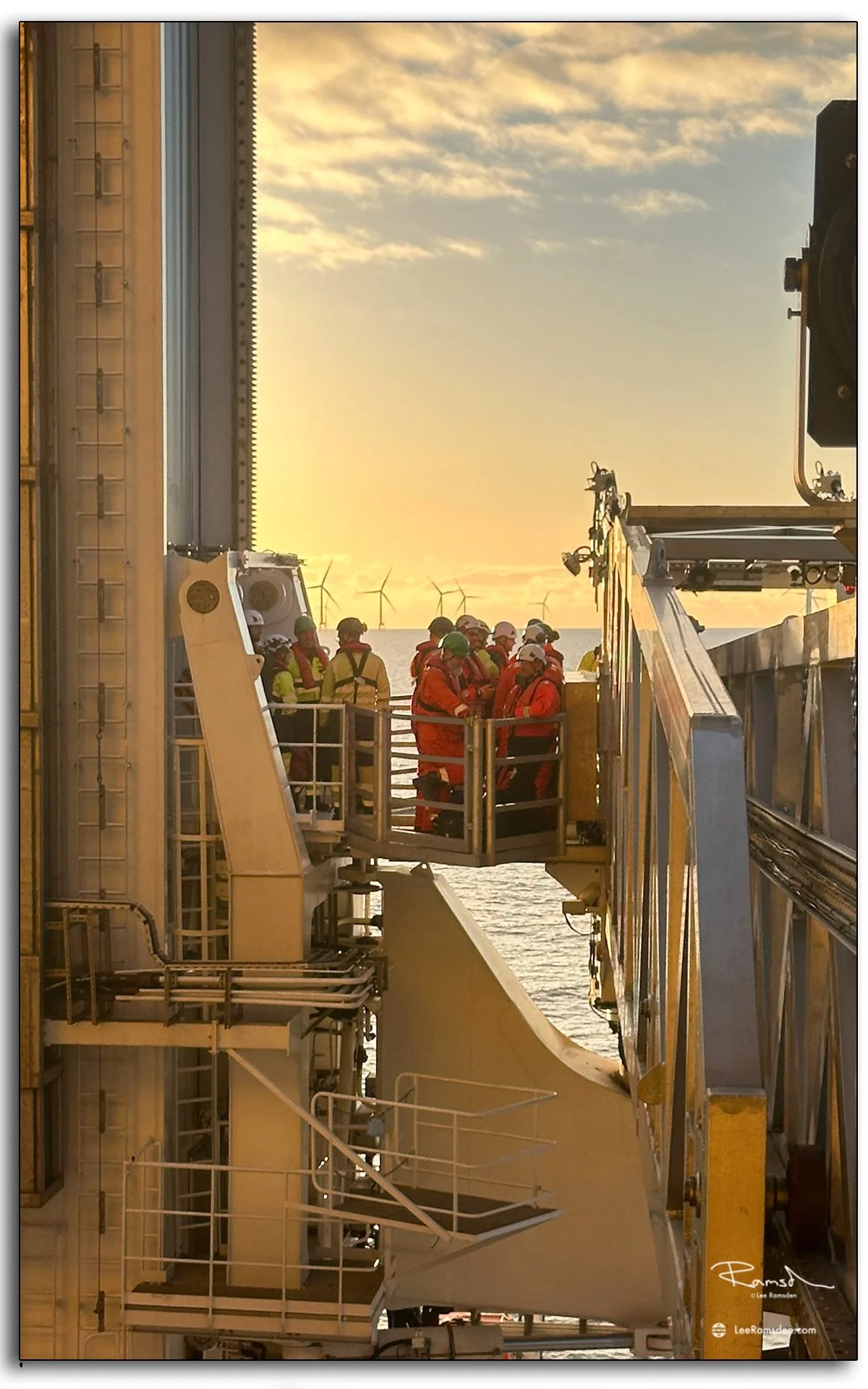 Offshore crew gathered in PPE, preparing to transfer via Walk-to-Work bridge.