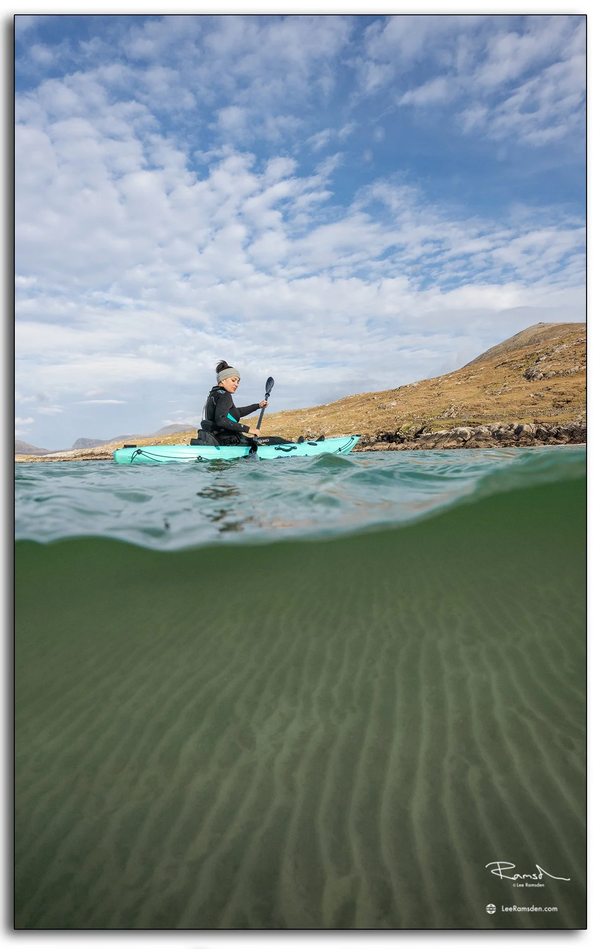 Woman in wetsuit with kayaks on Luskentyre Beach, Isle of Harris, Outer Hebrides, Scotland
