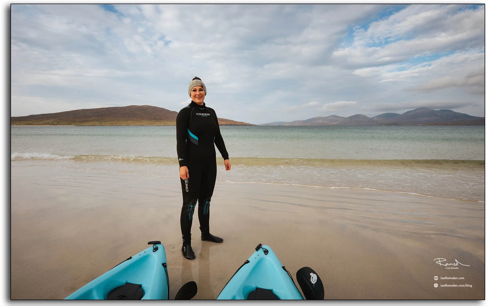 Woman in wetsuit with kayaks on Luskentyre Beach, Isle of Harris, Outer Hebrides, Scotland
