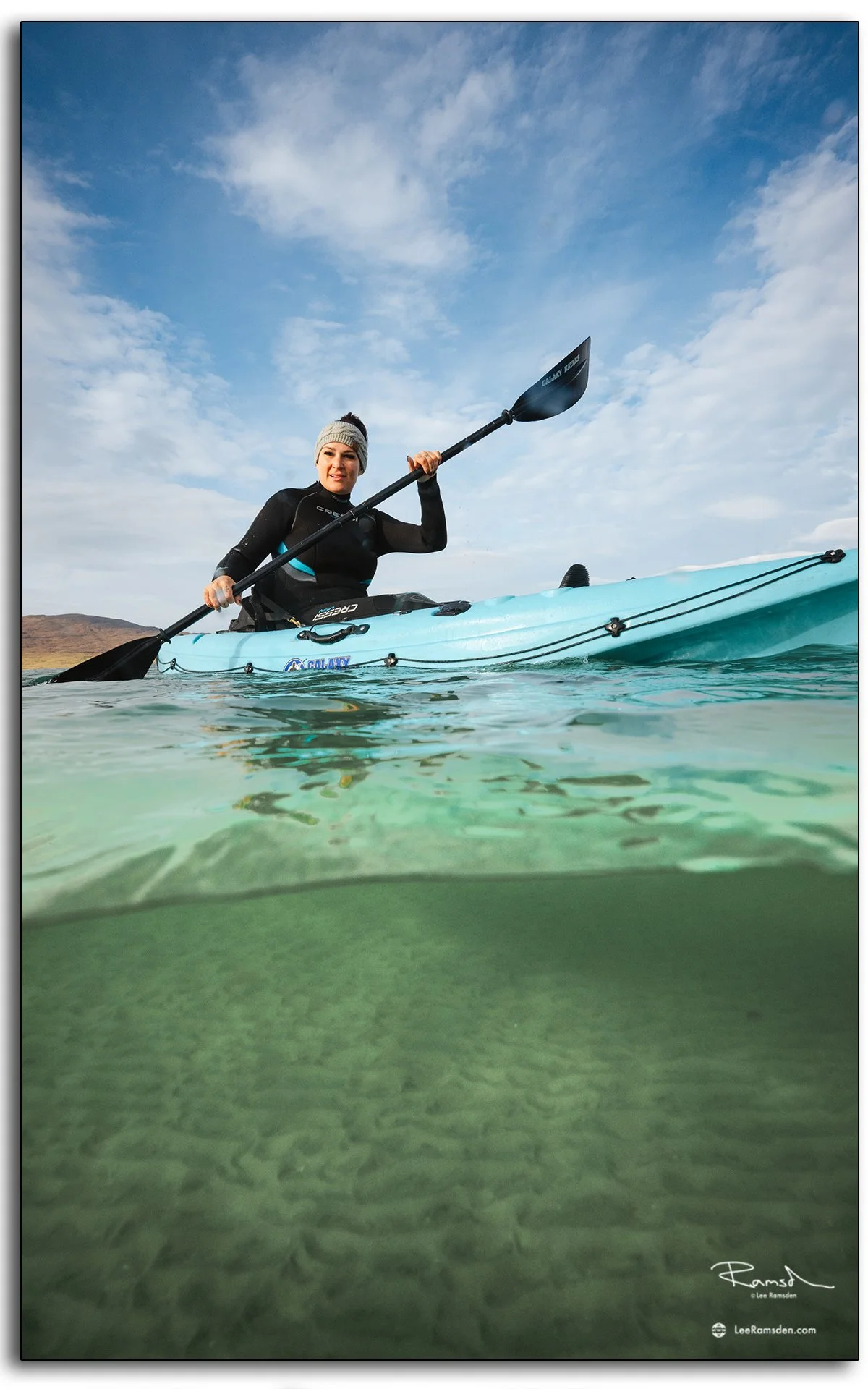 Woman in wetsuit with kayaks on Luskentyre Beach, Isle of Harris, Outer Hebrides, Scotland