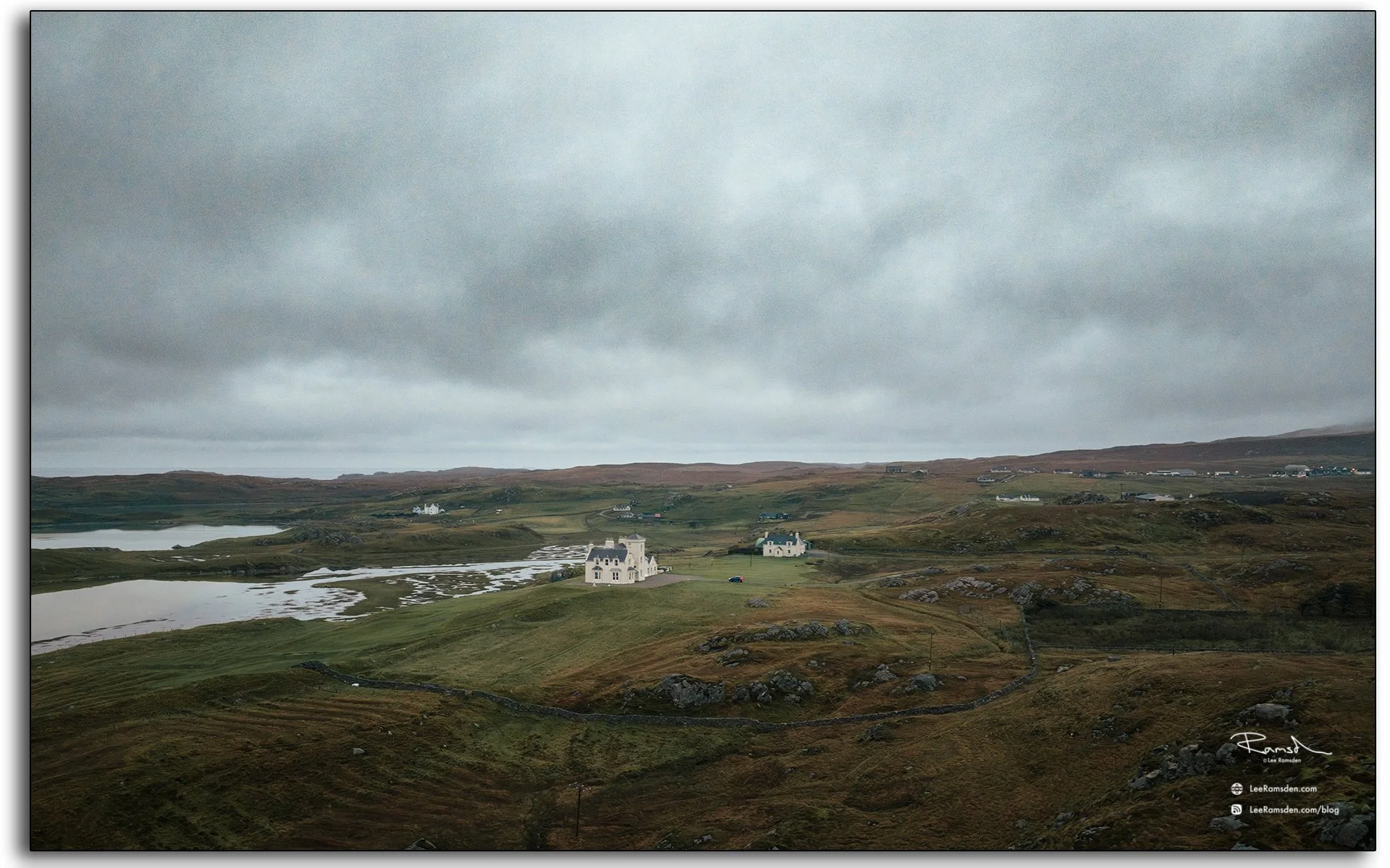 Uig Lodge on the Isle of Lewis, Outer Hebrides, surrounded by rugged moorland and lochs under a moody grey sky