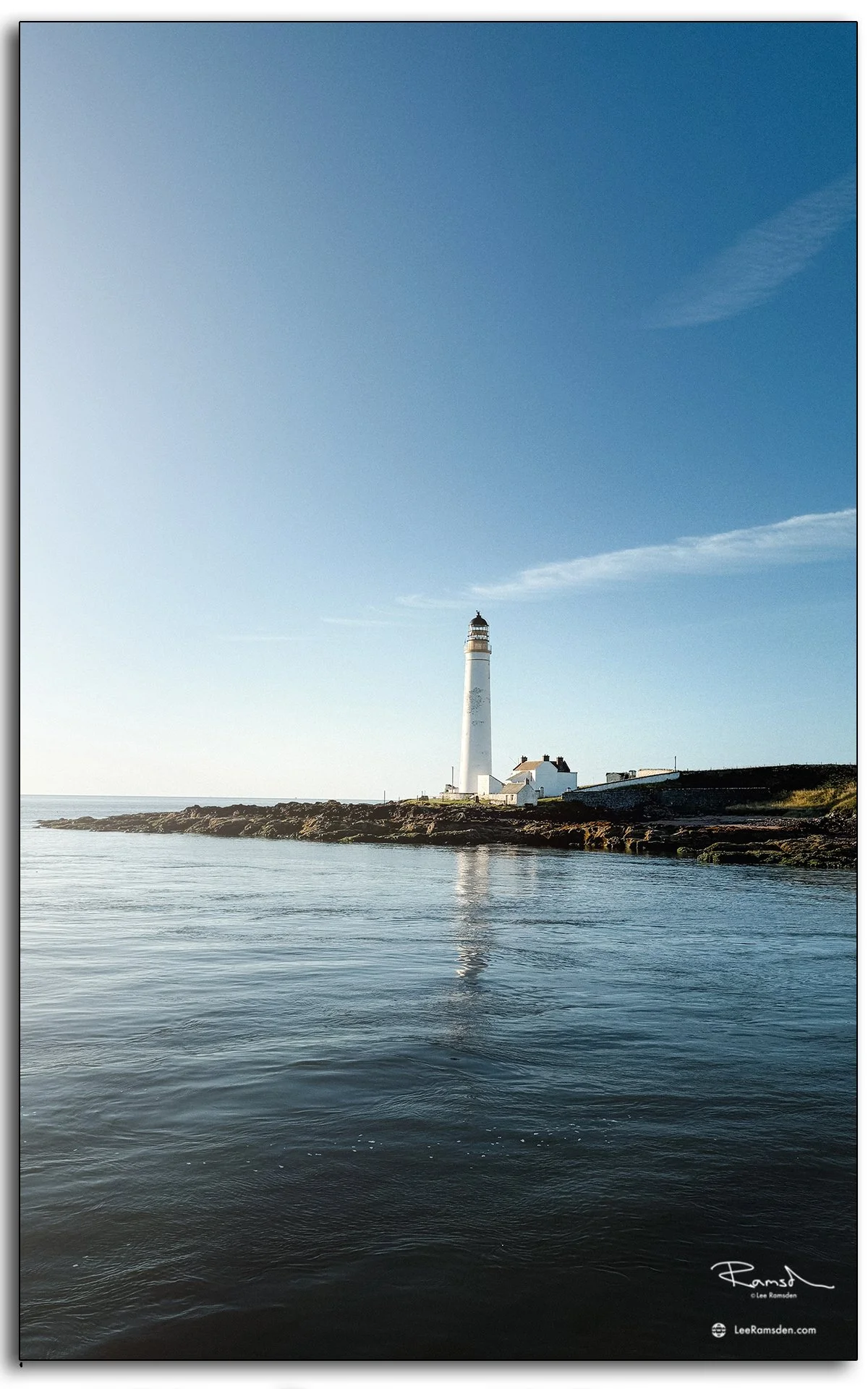 Scurdie Ness Lighthouse Montrose with calm blue skies and reflection in the sea